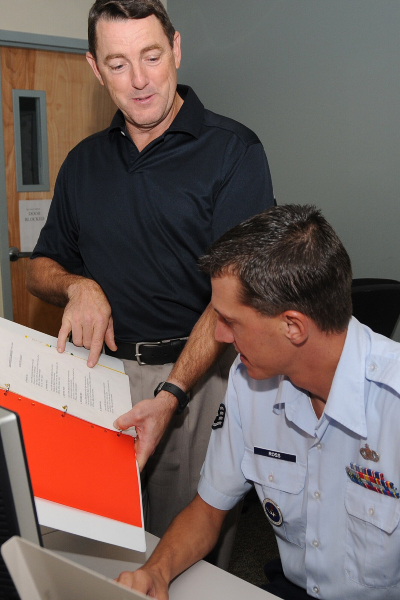 Mr. Riley, left, and Staff Sgt. Scott Ross, a 334th TRS instructor, verify that an airfield management lab script meets Air Force standards.  (U.S. Air Force photo by Kemberly Groue)