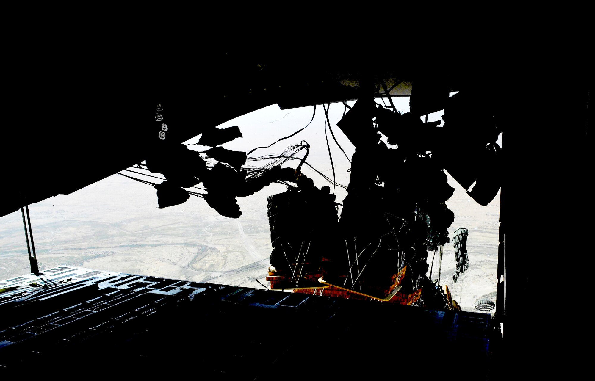 Container delivery system bundles full of supplies are dropped out of a C-17 Globemaster III Sept. 23, 2009, over a base in Afghanistan. (U.S. Air Force photo/Staff Sgt. Angelita Lawrence) 