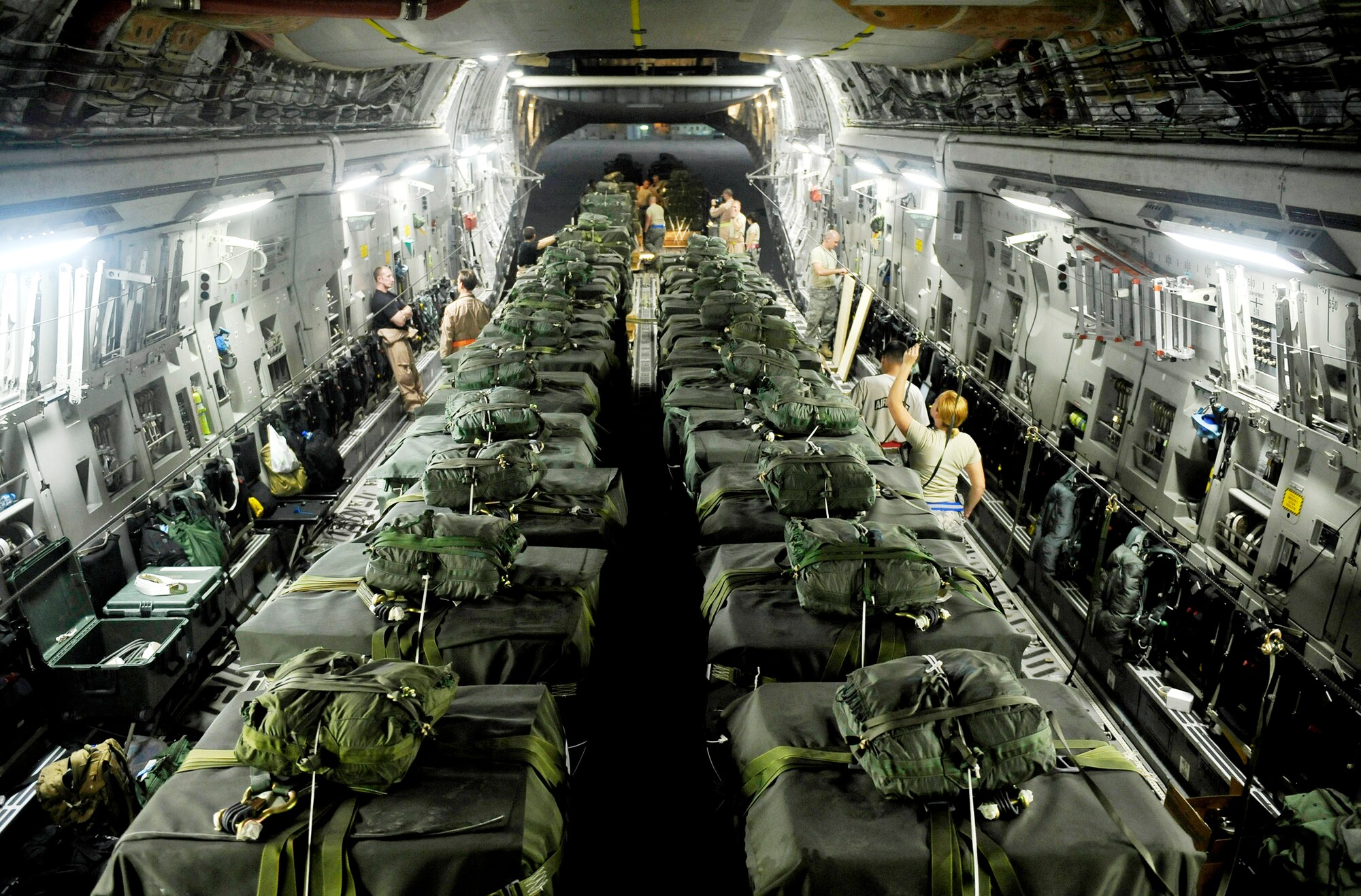 Servicemembers load a C-17 Globemaster III with container delivery system bundles Sept. 23, 2009, at an air base in Southwest Asia. More than 4.1 million pounds of supplies were airdropped by the Air Force in the month of September. (U.S. Air Force photo/Staff Sgt. Angelita Lawrence)