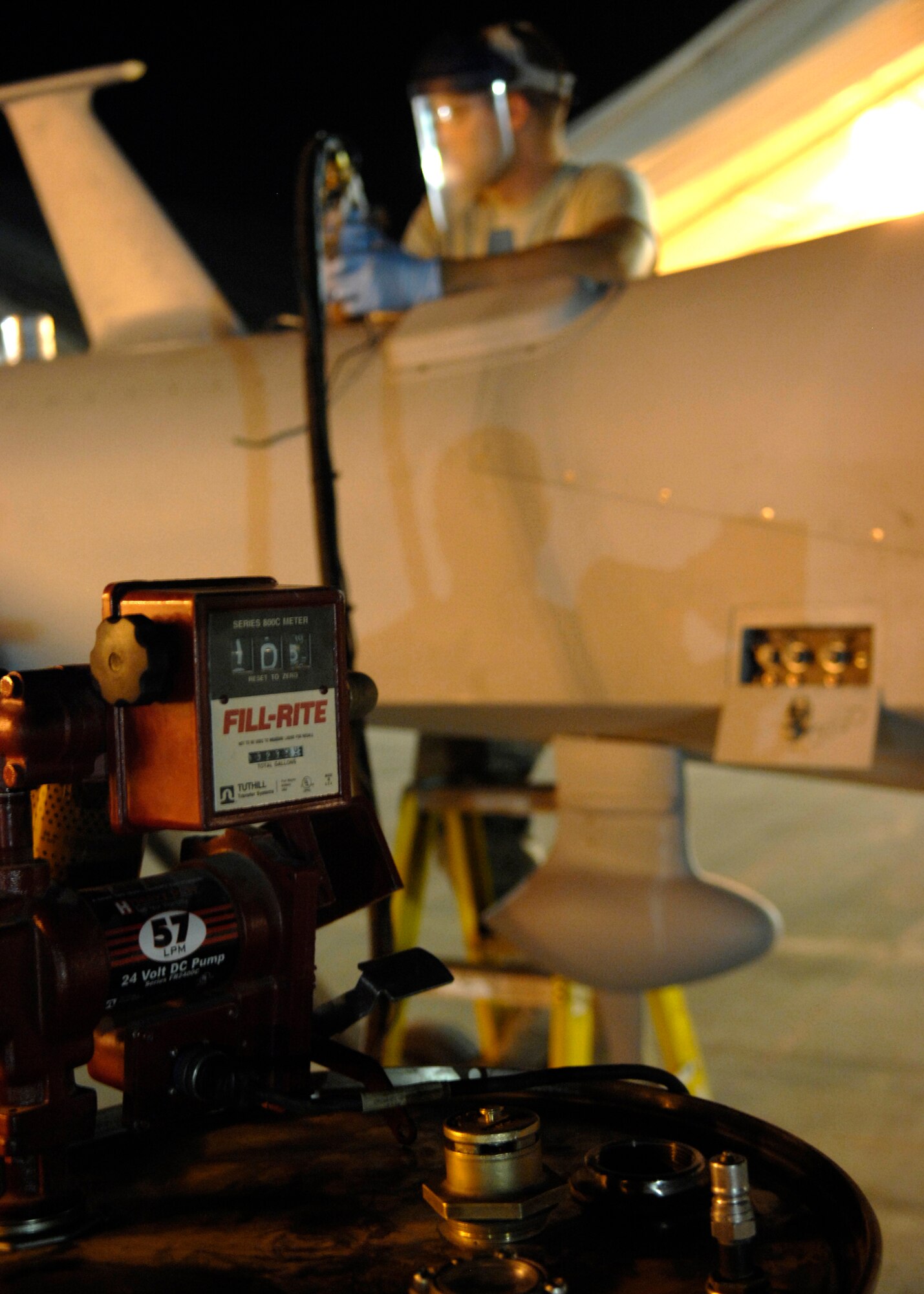 Airman 1st Class Patrick Carlson refuels an MQ-1 Predator here Sept. 23, 2009. The Unmanned Aerial Vehicles are currently the only aircraft on Kandahar Airfield that don't have dedicated refueling vehicles, but rather require Airmen at the 62nd to refuel the aircraft themselves. Airman Carlson is a crew chief for the 62nd  Expeditionary Reconnaissance  Squadron from Creech Air Force Base, Nev. (U.S. Air Force photo/Senior Airman Timothy Taylor)