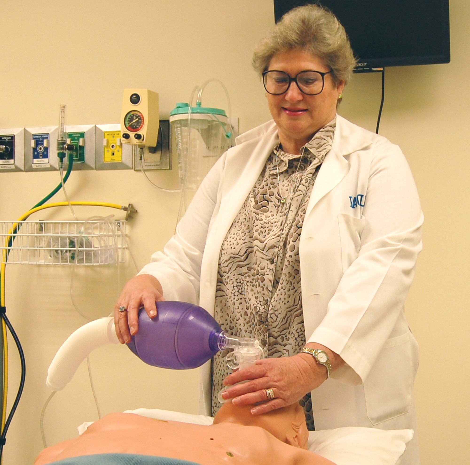 Ms. Mullins demonstrates using a bi-valve mask on a patient simulator in the medical center’s patient simulation laboratory.  (U.S. Air Force photo by Steve Pivnick)