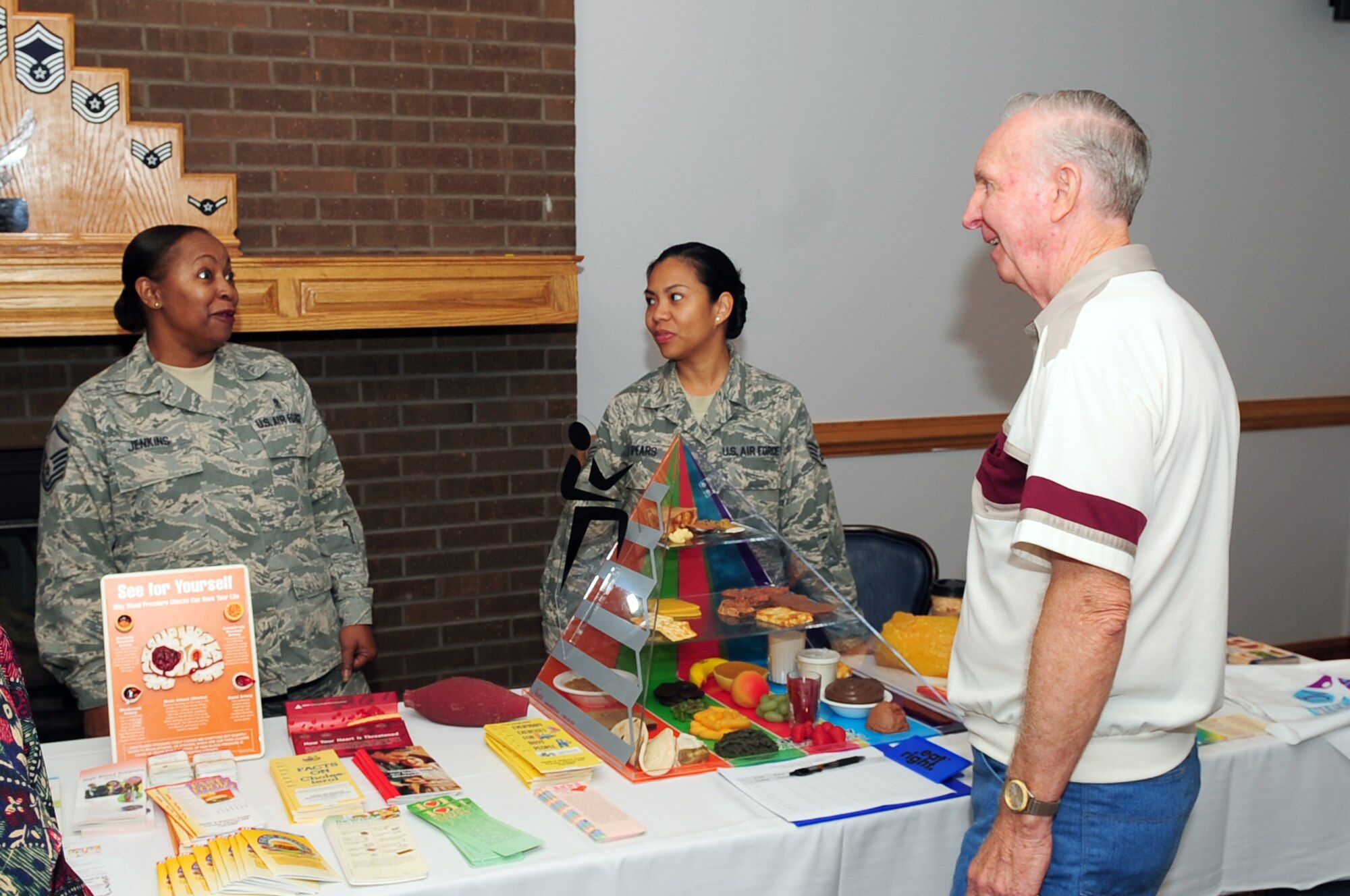 Master Sgt. Tamyara Jenkins and Staff Sgt. Celeste Pears, 4th Aeromedical Dental Squadron, speaks to a retiree about healthy diet and exercise routines during Retiree Appreciation Day at Seymour Johnson Air Force Base, N.C., Sept. 19, 2009. The 4th ADOS also provided cholesterol tests and had physical therapy Airmen on hand to ensure retirees were aware of services offered at the clinic. (U.S. Air Force photo/Airman 1st Class Rae Perry)
