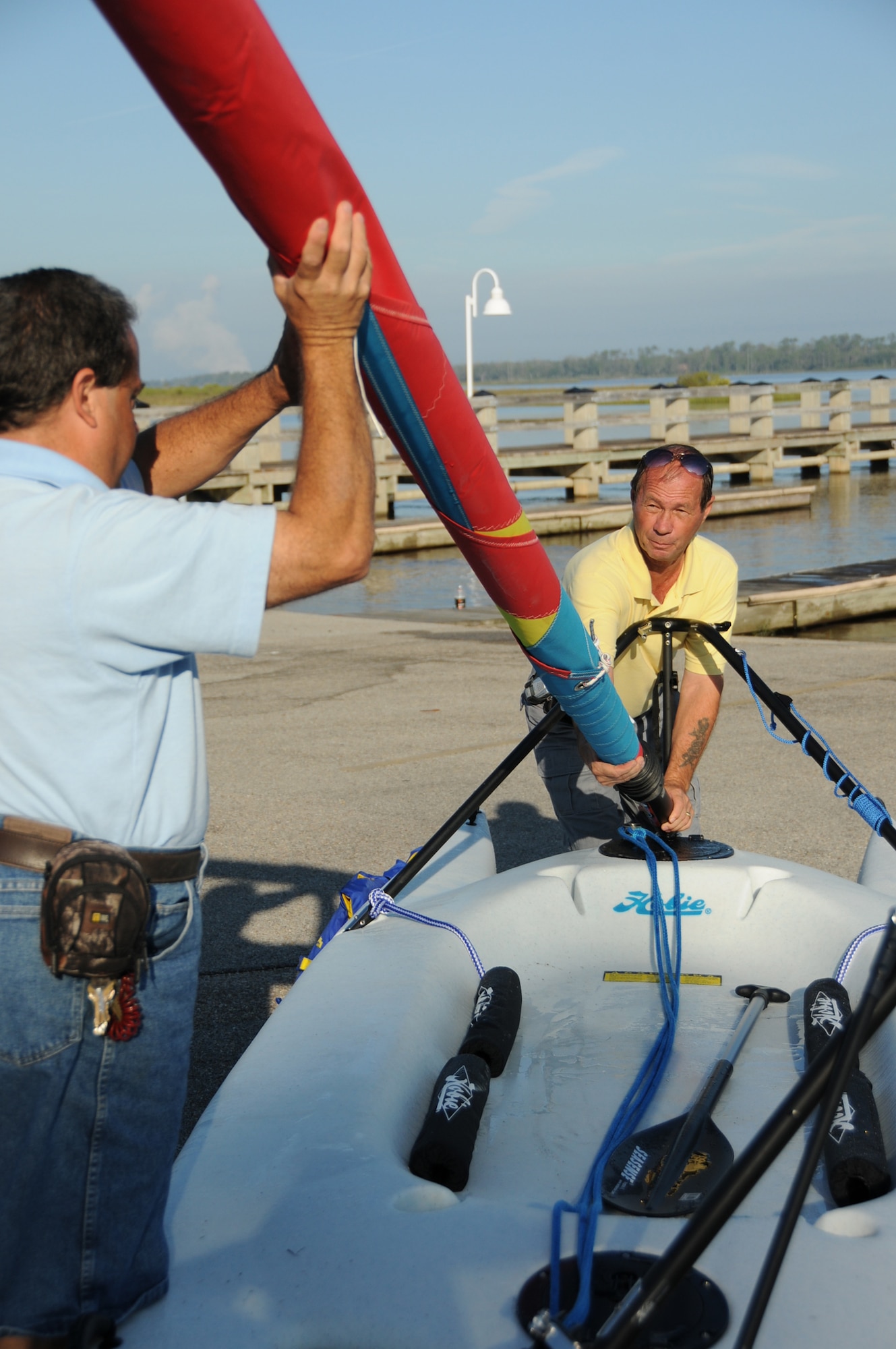 Chris Papale, left, and Wayne Fortier, 81st Force Support Squadron, prepare a new catamaran sailboat for outdoor recreation’s first introductory sailboating class, 9 a.m. Friday.  The $40 class consists of two hours classroom training and four hours of sailing and is required to rent sailboats on base.  Rentals are $10 hour (minimum two hours) or $75 day.  To rent a trailer and take a boat offsite costs $100 per day or $175 for a weekend.  For more information, call 377-3160.  (U.S. Air Force photo by Kemberly Groue)