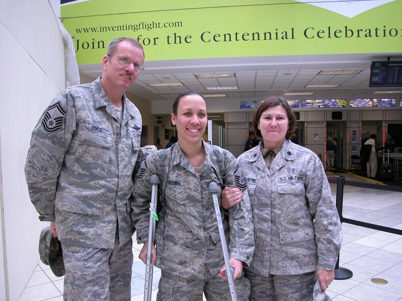 WRIGHT-PATTERSON AIR FORCE BASE, Ohio – Master Sgt. Carie Brown is greeted by Senior Master Sgt. Brian Fowle, 445th Aeromedical Evacuation Squadron superintendent of inflight medical care, and Lt. Col. Linda Stokes-Crowe, 445th AES commander, at the Dayton International Airport Sept. 30 after returning from a 120-day deployment to Southwest Asia.  More than 10 reservists from AES returned from deployments this week.  (U. S. Air Force photo/Chief Master Sgt. Peri Rogowski)
