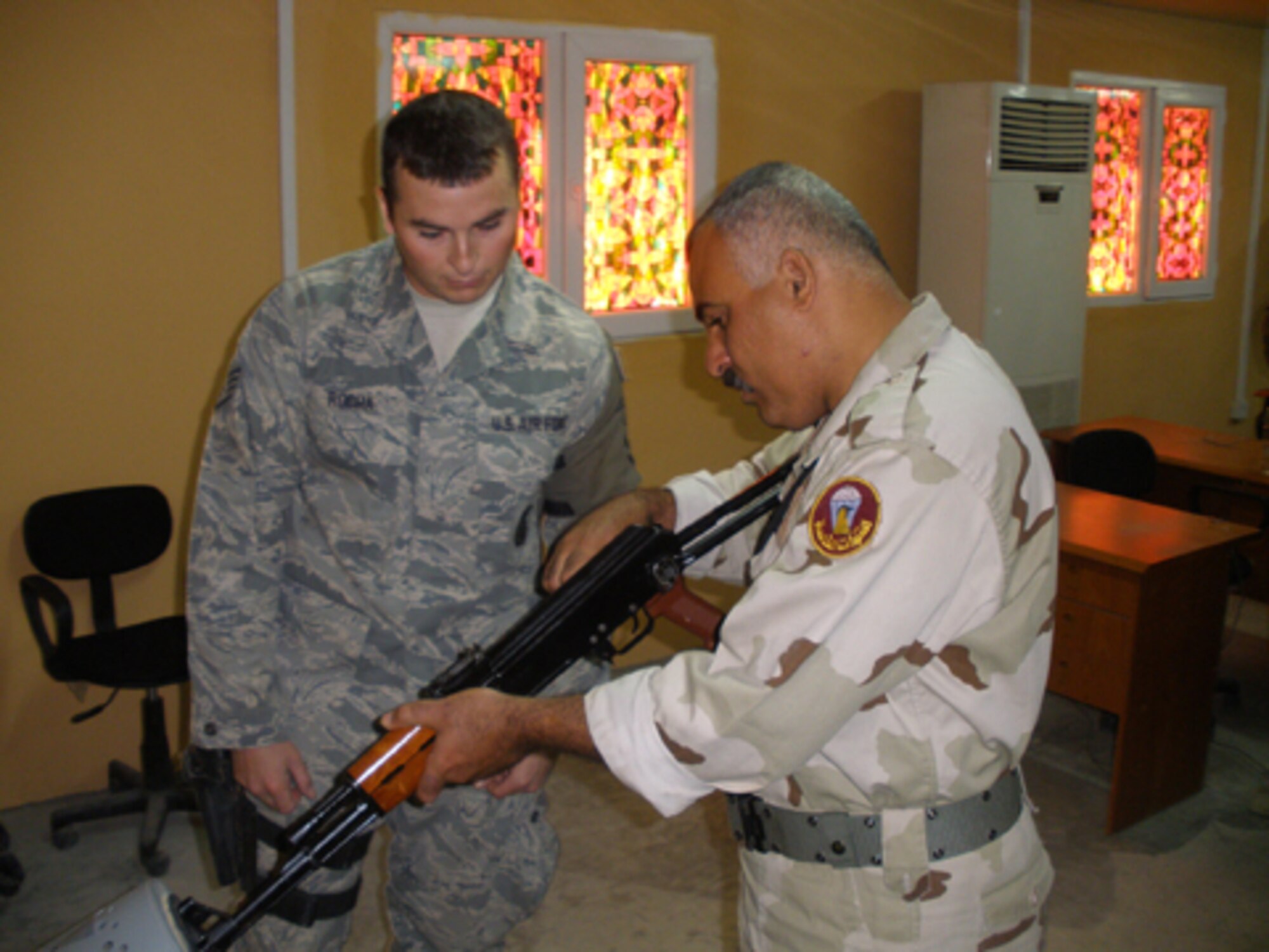 While deployed to the 506th Expeditionary Security Forces Squadron, Kirkuk, Iraq, Senior Airman Nathanial Rocha, a 512th SFS member, is assigned to train Iraqi Air Force members on turn-in and break-down procedures of the AK-47 as well as on challenging and searching. (U.S. Air Force photo)