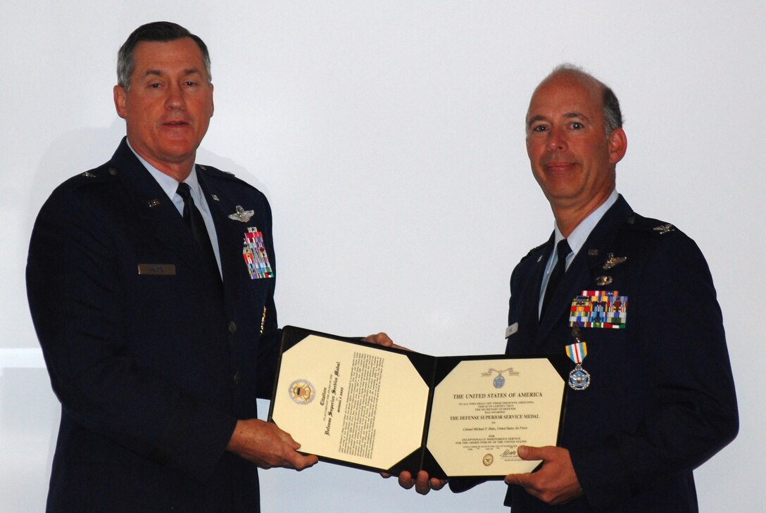 During a senior staff meeting Col. Michael Hake, 82nd Training Wing vice commander, is awarded The Defense Superior Service Medal from Brig. Gen. O.G. Mannon, 82nd Training Wing commander, Sept. 30. He received this medal for distinguishing himself by showing superior service while serving as Test Director for the Joint Non-Kinetic Effects Integration Joint Test and Deputy Chief of the Strategic Command, Offutt Air Force Base, Neb., from June 2005 through June 2009.(U.S. Air Force photo/ Master Sgt. Richard Coleman)