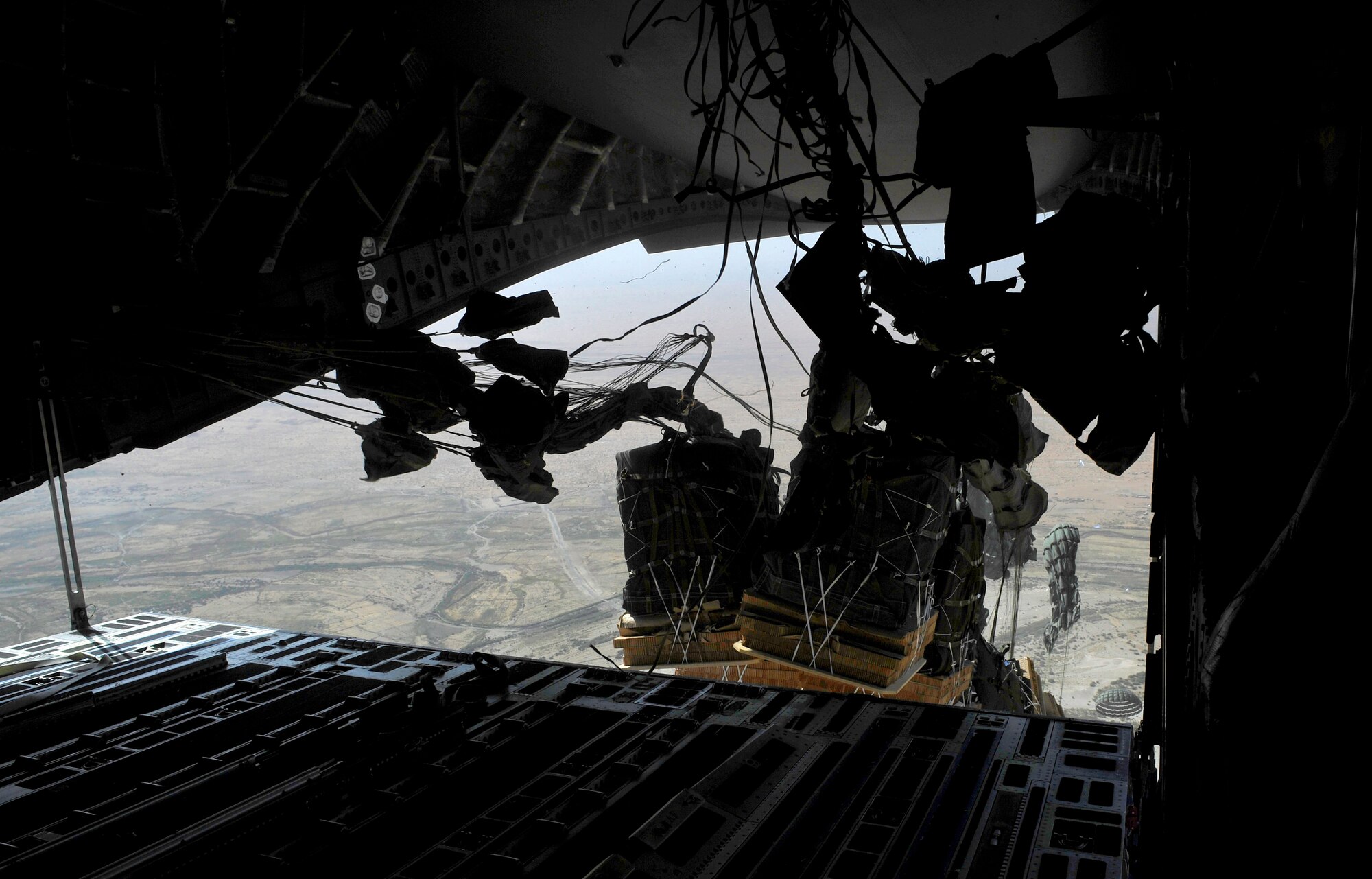 Container Delivery System bundles full of supplies are dropped out of a C-17 Globemaster III over a base in Afghanistan Sept. 23, 2009.  (U.S. Air Force photo/Staff Sgt. Angelita Lawrence)