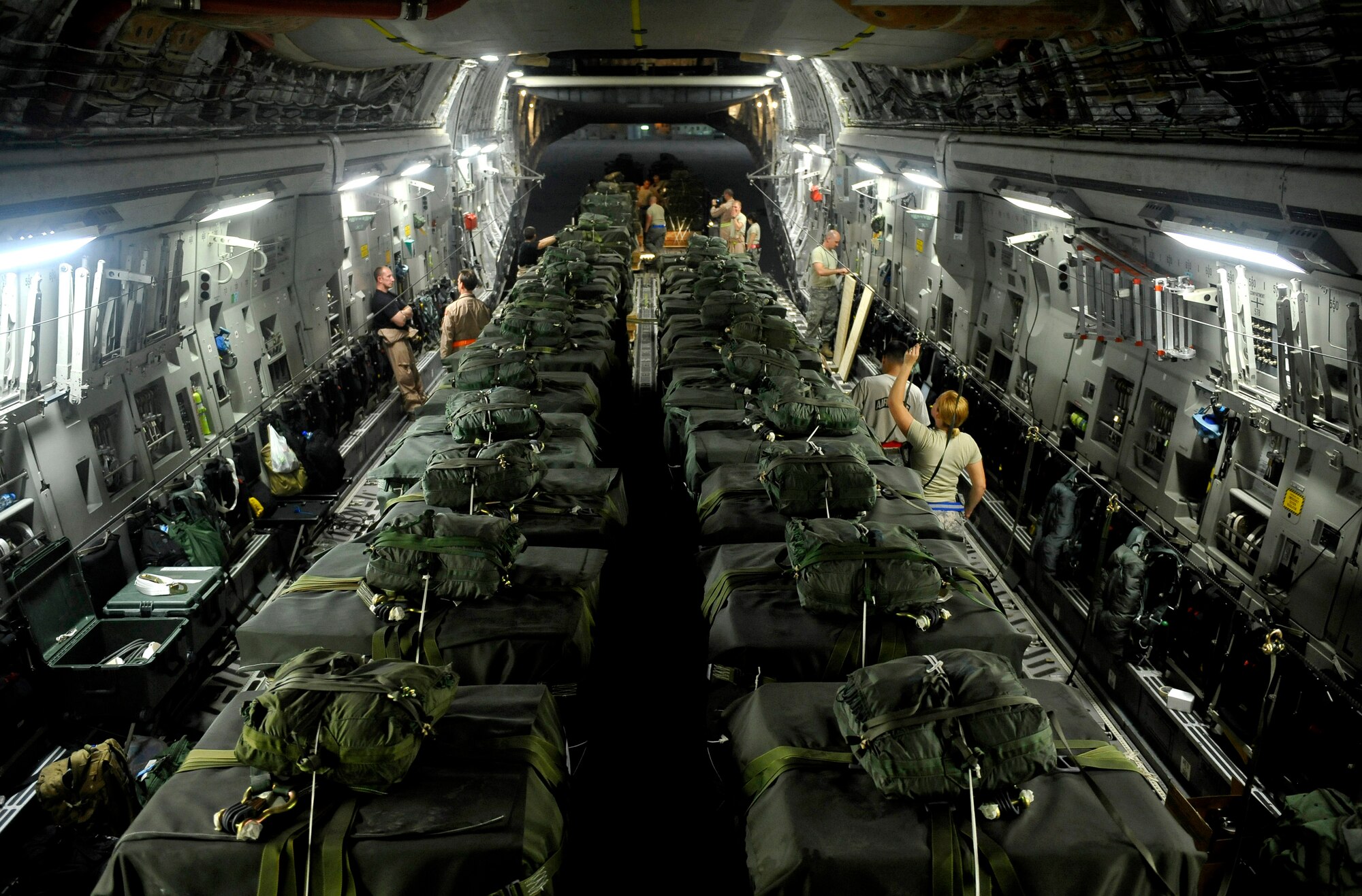 U.S. servicemembers, deployed to a base in Southwest Asia, load a C-17 Globemaster III with Container Delivery System bundles Sept. 23, 2009. More than 4.1 million pounds of supplies were airdropped by the U.S. Air Force in the month of September.  (U.S. Air Force photo/Staff Sgt. Angelita Lawrence)