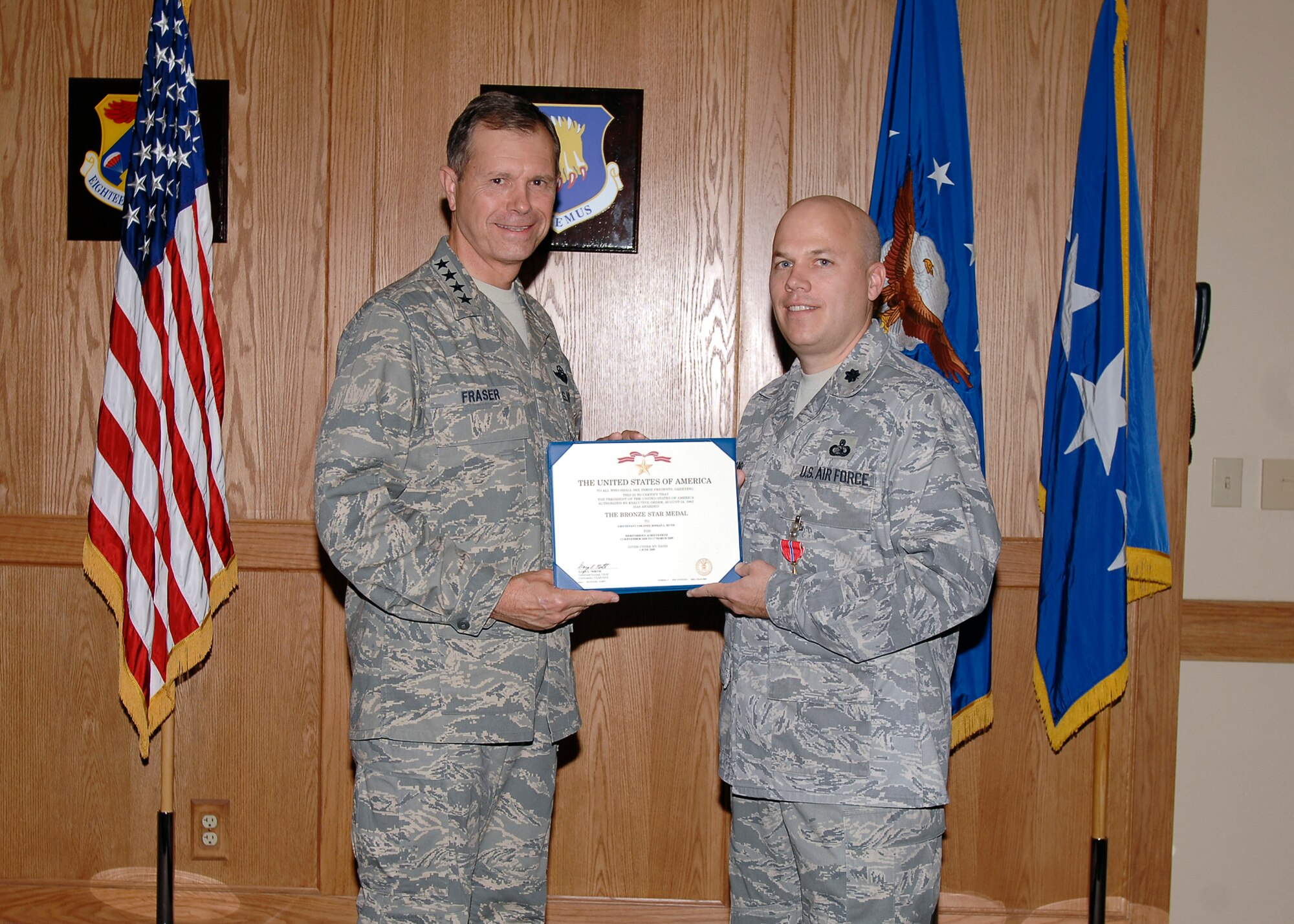 Gen. William M. Fraser III, Air Combat Command commander, presented Lt. Col. Roman Hund, 22nd Mission Support Group deputy commander, with the Bronze Star Medal at McConnell Air Force Base, Kan., Sept. 25, 2009. Colonel Hund received the Bronze Star for an outstanding job performance while deployed to Iraq, according to the award citation. The Bronze Star is the fourth-highest combat award U.S. military members can receive. (U.S. Air Force photo/Senior Airman Jose Mejia)