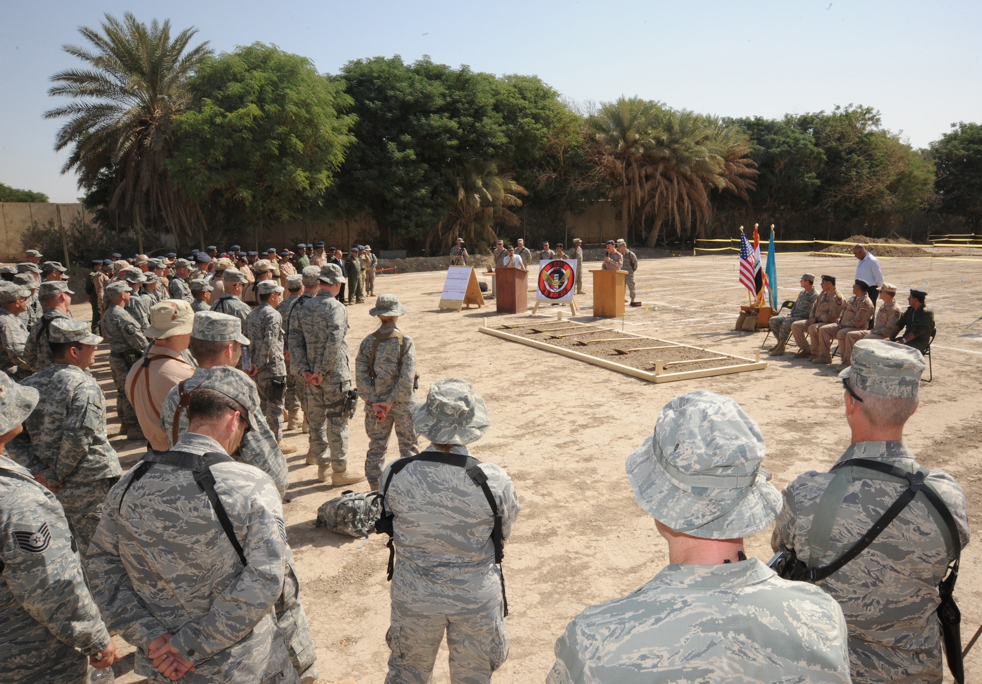 HAWK BASE, Iraq -- U.S. and Iraqi Air Force members look on as the Iraqi Air Operations Center ground breaking ceremony commences here Sept. 30, 2009.  The new AOC will play a central role in the growth and future success of the Iraqi air force and will be key to maintaining a secure, stable and sovereign Iraq. (U.S. Air Force photo/Tech. Sgt. Johnny L. Saldivar)