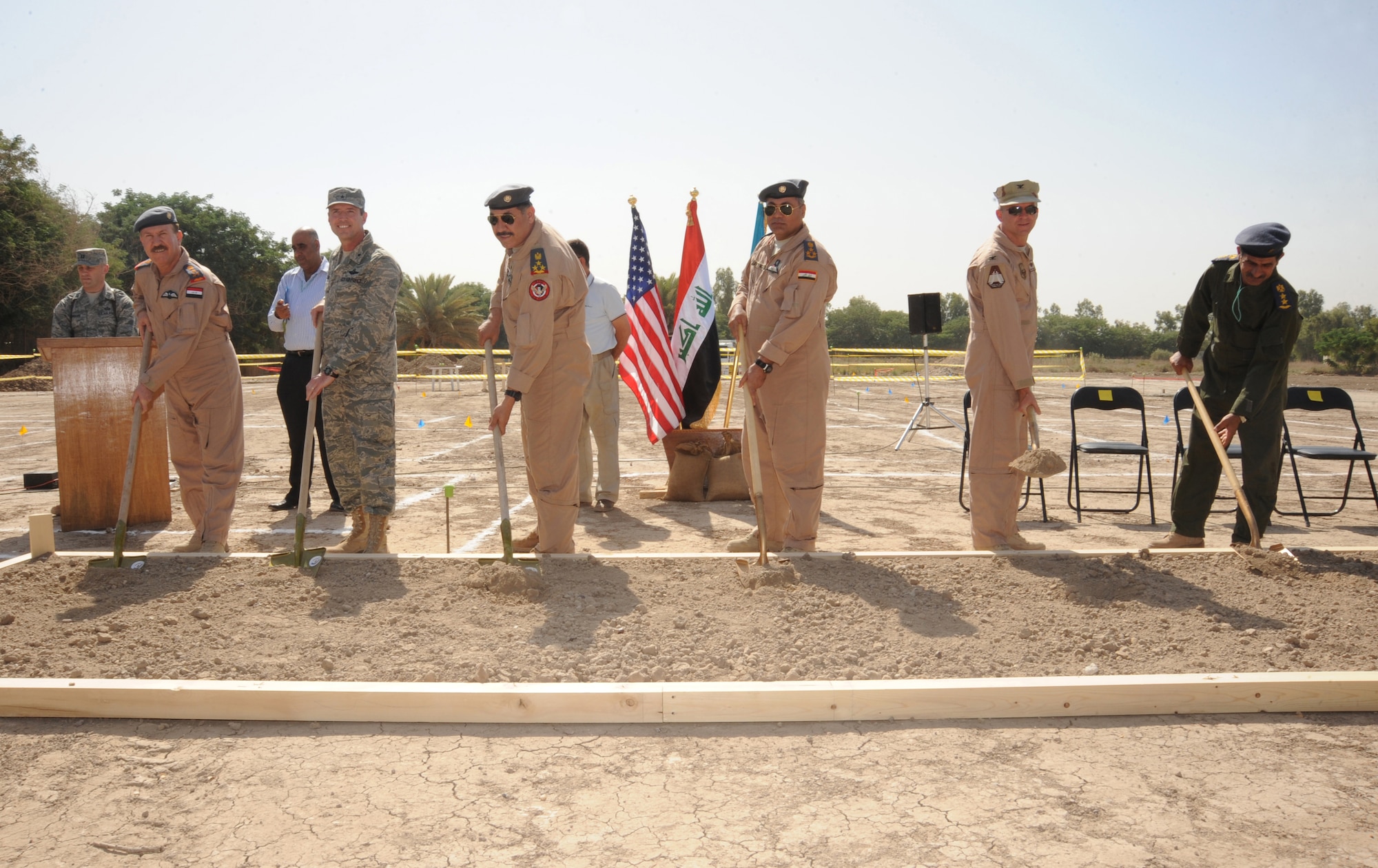 HAWK BASE, Iraq -- U.S. and Iraqi Air Force members dig the first shovels full of dirt at the Iraqi Air Operations Center ground breaking ceremony here Sept. 30, 2009.  The new AOC will play a central role in the growth and future success of the Iraqi air force and will be key to maintaining a secure, stable and sovereign Iraq. (U.S. Air Force photo/Tech. Sgt. Johnny L. Saldivar)