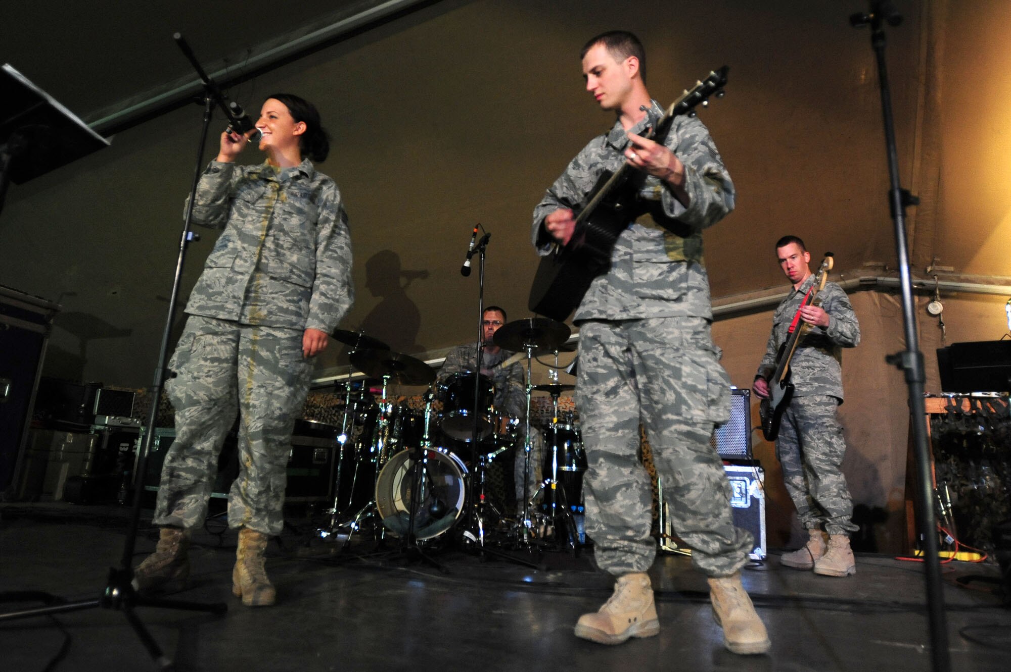 TRANSIT CENTER AT MANAS, Kyrgyzstan -- Staff Sgt. Erica Still, 376th Expeditionary Force Support Squadron stock room non-commissioned officer in charge and recent Manas Idol winner, performs a song with Staff Sgt. Clinton Whitney and the U.S. Air Forces Central Command 'Falcon' Band during a show at Pete's Place, Sept. 27, 2009. Sergeant Whitney and the 'Falcon' Band members are stationed at a base in Southwest Asia and are deployed from Offutt Air Force Base, Neb. Sergeant Still is deployed from the 193rd FSS at the Harrisburg International Airport, Pa. and is originally from Harrisburg, Pa. (U.S. Air Force photo/Senior Airman Steele C. G. Britton)