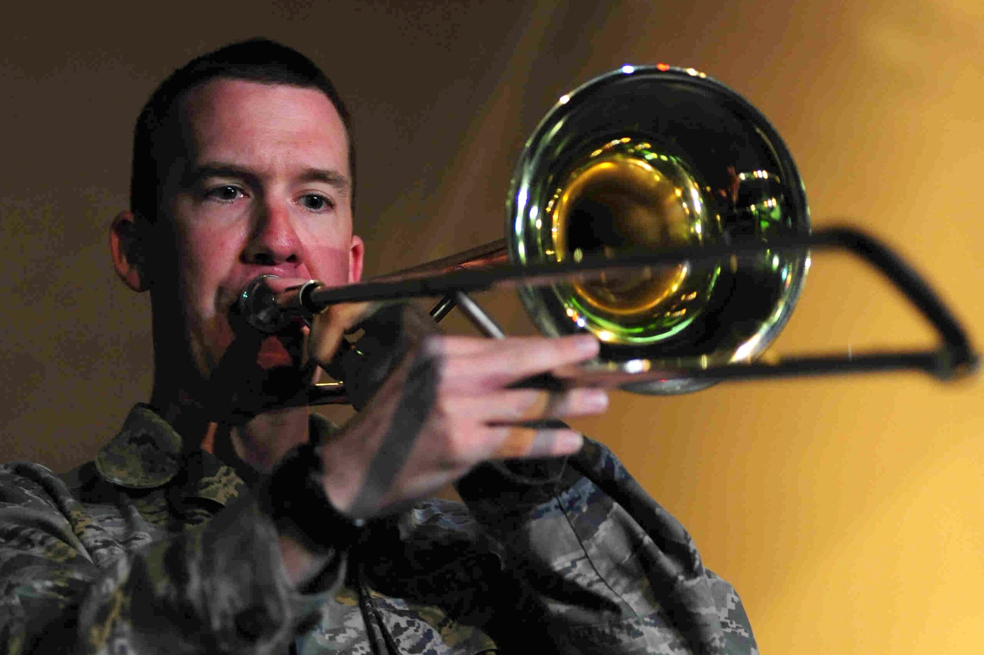 TRANSIT CENTER AT MANAS, Kyrgyzstan -- Staff Sgt. Benjamin Kadow, U.S. Air Forces Central Command 'Falcon' Band trombone player, plays a sol during a performance at Manas, Sept. 27, 2009. Sergeant Kadow and the 'Falcon' Band members are stationed at a base in Southwest Asia and are deployed from Offutt Air Force Base, Neb. (U.S. Air Force photo/Senior Airman Steele C. G. Britton)
