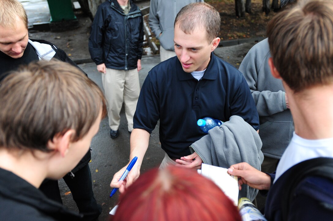 BISHKEK, Kyrgyzstan -- Staff Sgt. Clinton Whitney, U.S. Air Forces Central Command 'Falcon' Band vocalist, is surrounded by fans wanting autographs following a performance at the Third-Annual Student Rock Festival at the American University of Central Asia, Sept. 26, 2009. Sergeant Whitney and the 'Falcon' Band members are stationed at a base in Southwest Asia and are deployed from Offutt Air Force Base, Neb. (U.S. Air Force photo/Senior Airman Steele C. G. Britton)