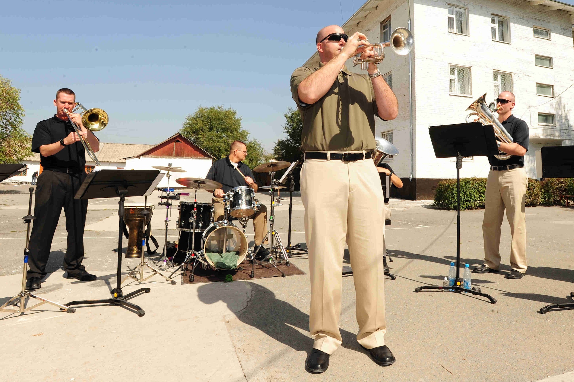 BISHKEK, Kyrgyzstan -- Staff Sgt. Eric Proper, U.S. Air Forces Central Command 'Falcon' Band trumpet player, performs a solo at the Bishkek Boarding School for the Blind and Visually-Impaired Children, Sept. 28, 2009. Sergeant Proper and the 'Falcon' Band members are stationed at a base in Southwest Asia and are deployed from Offutt Air Force Base, Neb. (U.S. Air Force photo/Senior Airman Steele C. G. Britton)
