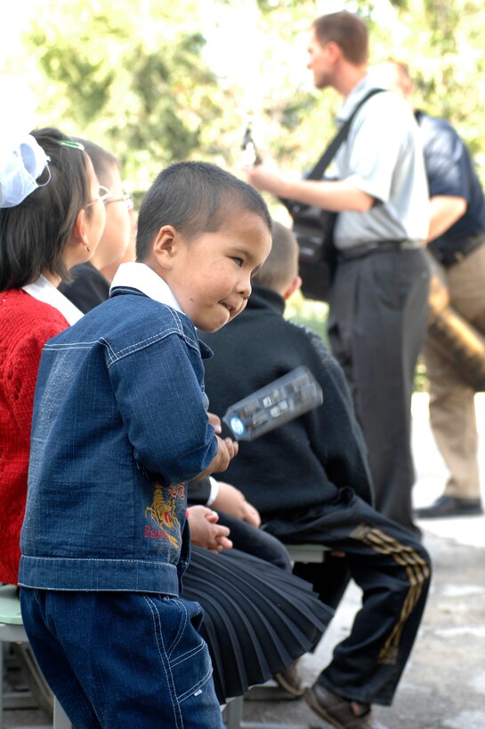 BISHKEK, Kyrgyzstan -- A young boy at the Bishkek Boarding School for the Blind and Visually-Impaired Children joins the music and dance during a U.S. Air Forces Central Command 'Falcon' Band performance, Sept. 28, 2009. The 'Falcon' Band members are stationed at a base in Southwest Asia and are deployed from Offutt Air Force Base, Neb.(U.S. Air Force photo/Senior Master Sgt. Andrew Lynch)