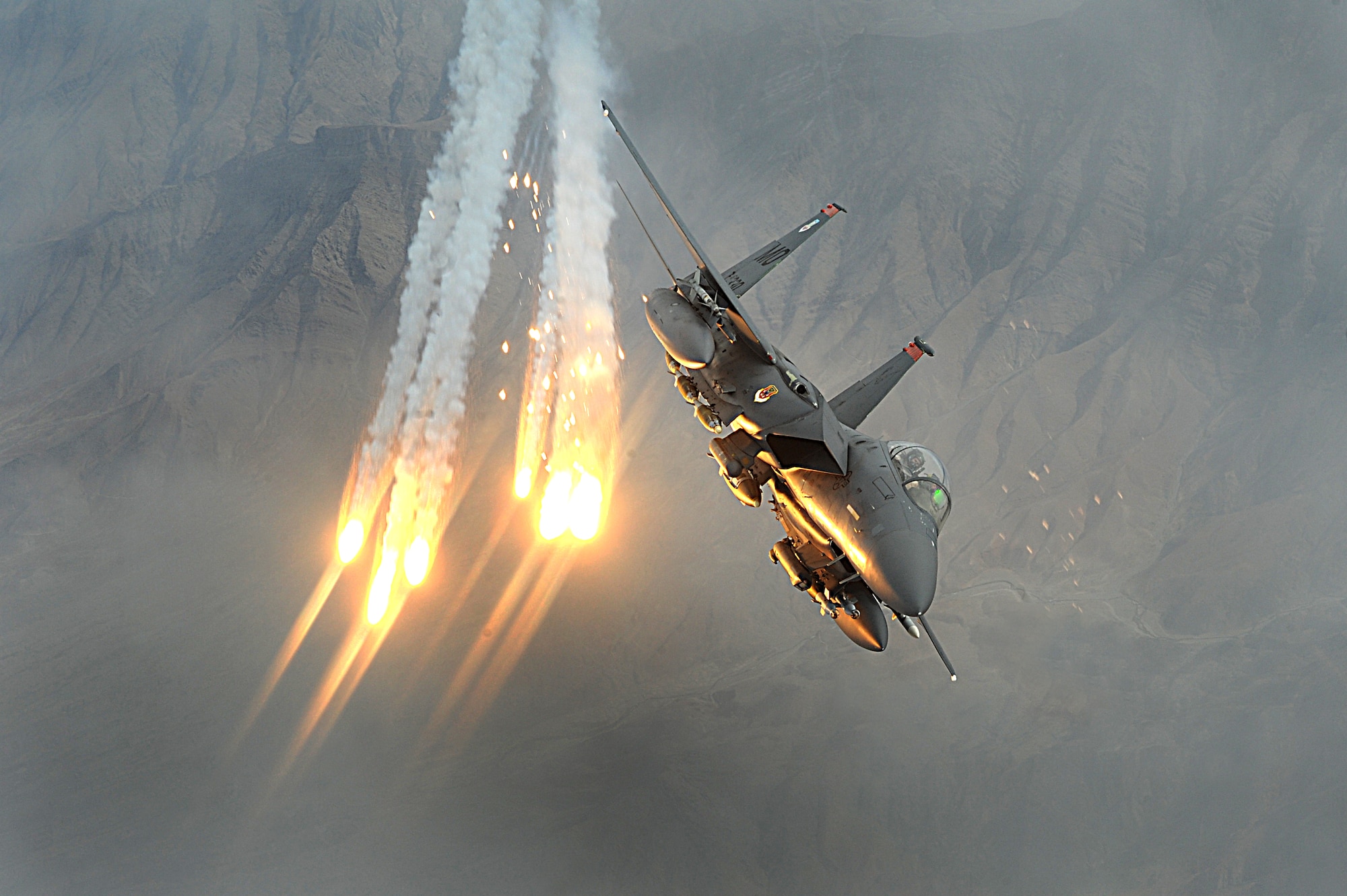 An F-15E Strike Eagle aircraft from the 391st Expeditionary Fighter Squadron, Bagram Air Base, Afghanistan, deploys heat decoys during a combat patrol over Afghanistan Dec. 15, 2008. (DoD photo by Staff Sgt. Aaron Allmon, U.S. Air Force/Released) 