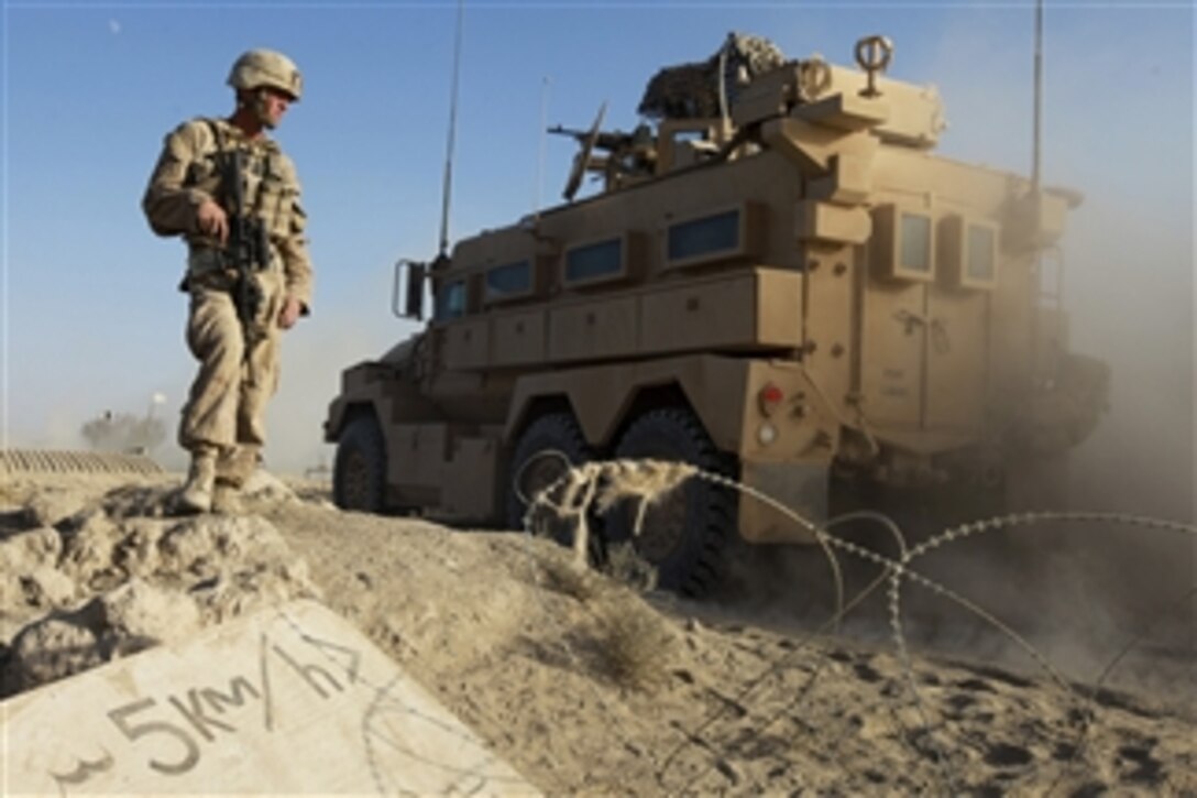 U.S. Marine Corps Lance Cpl. Daniel Lefebvre provides security as a convoy passes through an entry control point in the Nawa district of the Helmand province, Afghanistan, on Sept. 28, 2009.  Lefebvre is assigned to Alpha Company, 1st Battalion, 5th Marine Regiment, a combat element of Regimental Combat Team 3 that is deployed to conduct counterinsurgency operations in partnership with Afghan National Security Forces in southern Afghanistan.  