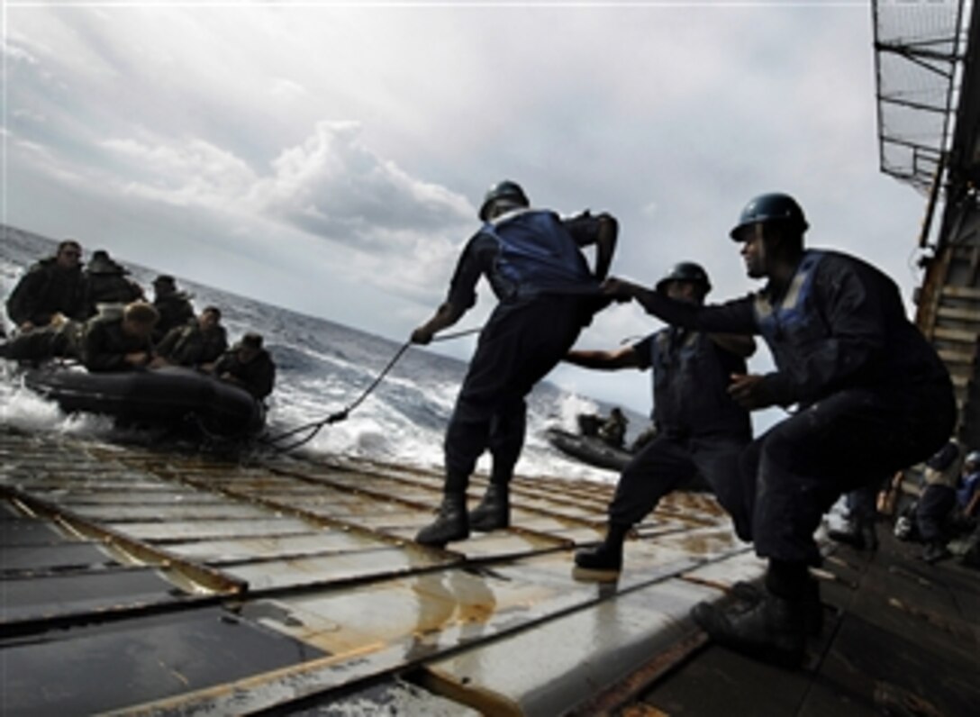 U.S. Navy sailors attached to the amphibious dock landing ship USS Harpers Ferry (LSD 49) work together with Marines from the 31st Marine Expeditionary Unit during combat rubber raid craft exercises in the Pacific Ocean on Sept. 29, 2009.  The Harpers Ferry is part of the USS Denver (LPD 9) Amphibious Task Group and is conducting amphibious integration training with the 31st Marine Expeditionary Unit off the coast of Okinawa, Japan.  