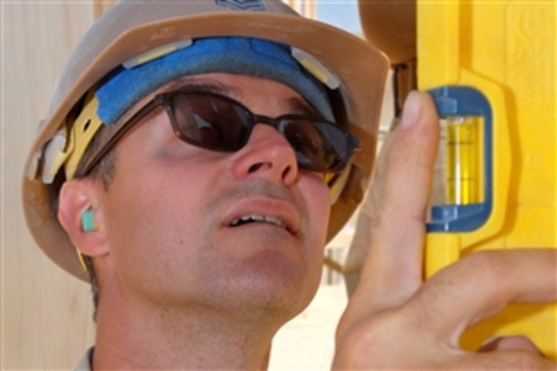 U.S. Navy Petty Officer 1st Class Russell Rea works on a construction project in Kandahar province, Afghanistan, Sept. 25, 2009. Rea is assigned to the Naval Mobile Construction Battalion 22 to build new facilities to improve working conditions at the 4th Engineer Battalion compound.