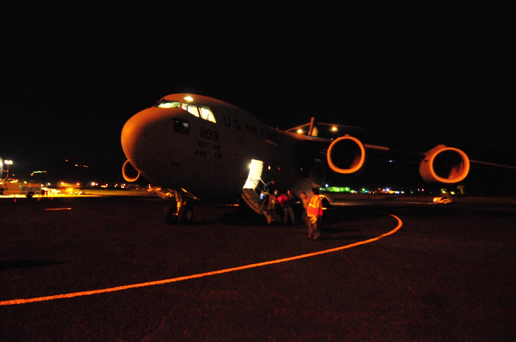 Federal Emergency Management Agency officials depart a C-17 Globemaster III from McChord Air Force Base, Wash., after arriving in Pago Pago, American Samoa, on Oct. 1, 2009. The mission was McChord's first airlift to the Samoan Islands in support of humanitarian relief efforts following the Sept. 29 tsunami. (U.S. Air Force photo/Capt. John Cortney)