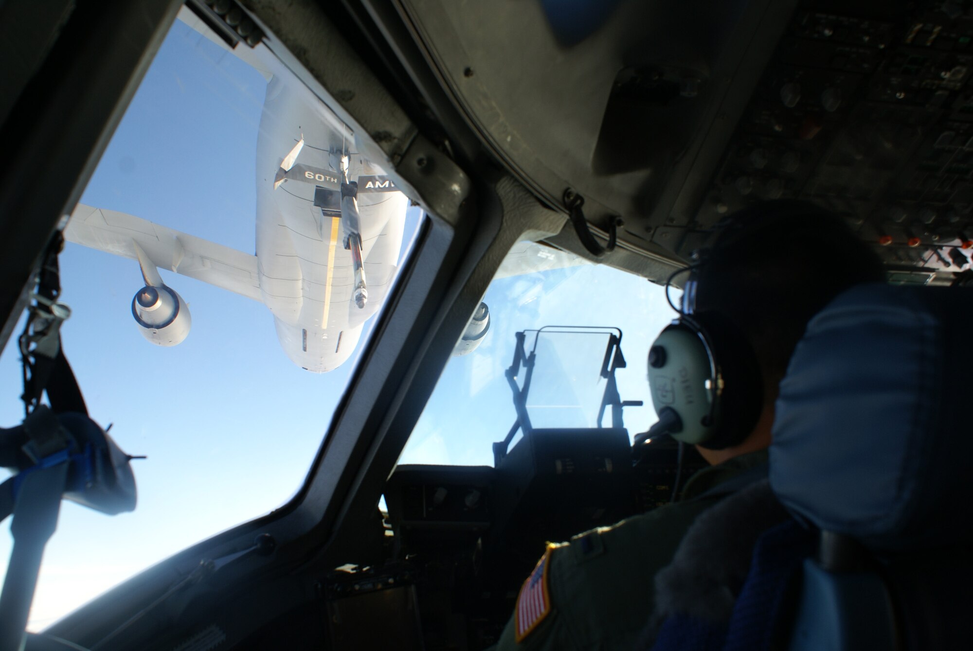 First Lt. Andre Dieu, a C-17 Globemaster III pilot with the 7th Airlift Squadron at McChord Air Force Base, Wash., prepares for an air refueling from a KC-135 Stratotanker from Travis AFB, Calif., over the Pacific Ocean Oct. 1, 2009. The C-17 was en route from McChord to Pago Pago, American Samoa, supporting humanitarian relief efforts for the region. On board was a team of nine Federal Emergency Management Agency officials and 17,000 pounds of communications equipment. (U.S. Air Force photo/Staff Sgt. Eric Burks)                     