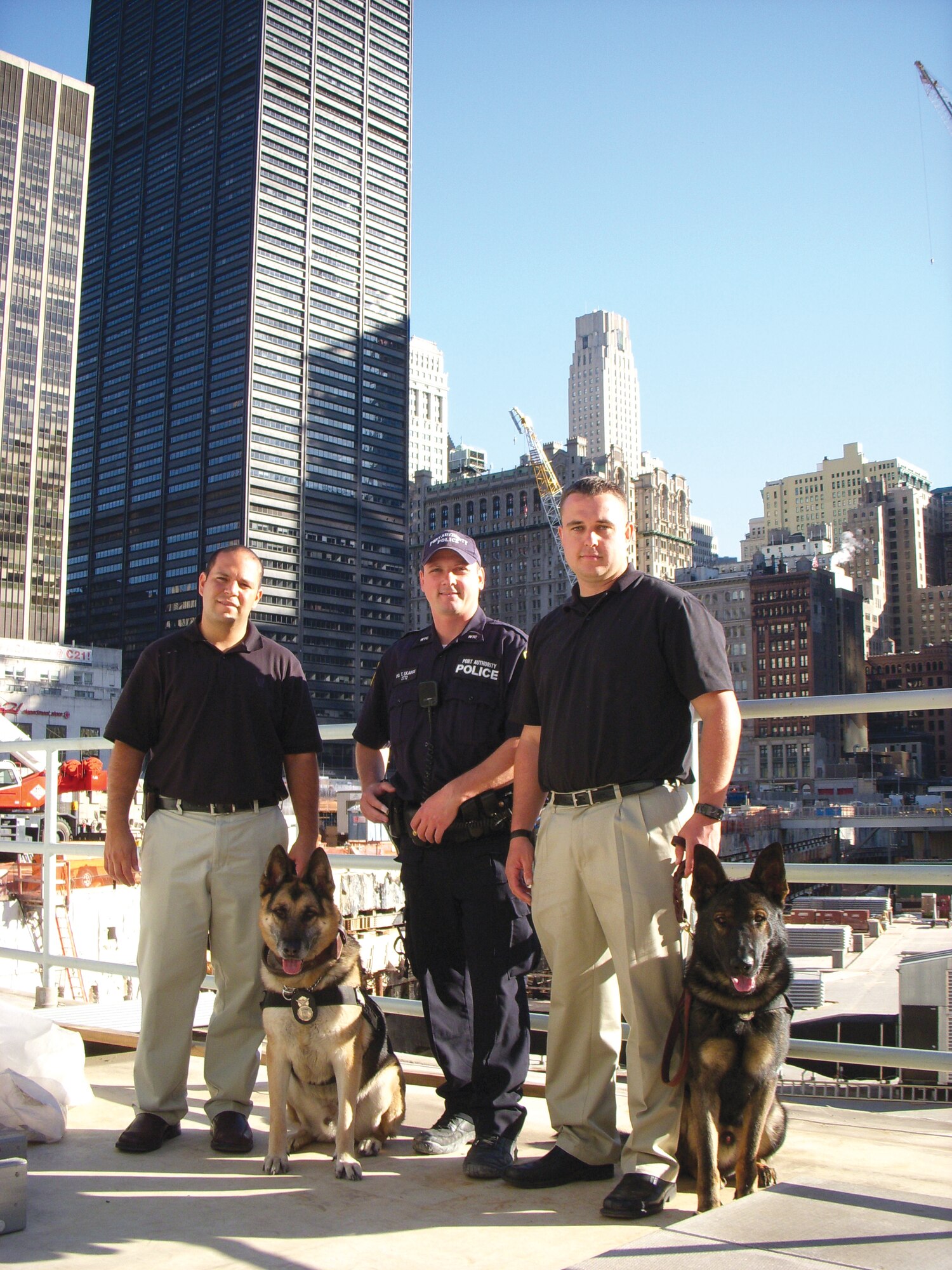 Staff. Sgt. Gabriel Bravo, 56th Security Forces Squadron military working dog trainer; military working dog Jampy; Terry Skaggs, Port Authority police officer; Staff. Sgt. Kyle Alltop, 56th SFS MWD handler, and MWD Chrach, pose for a photo during an exclusive tour of Ground Zero, Sept. 18. (courtesy photo)