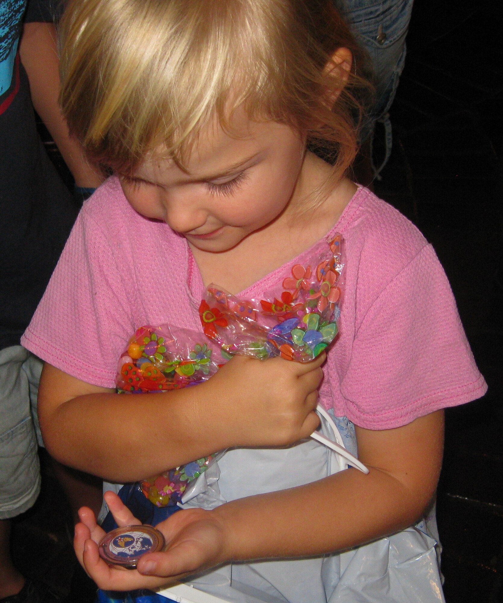 Challenge coins are a military tradition, and even the children attending the 349th Air Mobility Wing's first Yellow Ribbon Reintegration Program conference got one of their very own. Brig. Gen. Maryanne Miller had special childrens challenge coins made, and passed them out as she visited with families at the YRRP events. Hosted by the 349th Maintenance Group, the days activities began with an opening ceremony, briefings on a variety of information, prizes; games and goodies for children of all ages, and ended with a free spaghetti dinner followed by a town hall meeting with a question and answer session. The YRRP is a DOD sanctioned program for families and Airmen to provide assistance and support pre-, during and post-deployment. (U.S. Air Force photo/Command Chief Master Sgt. Kathleen Buckner)