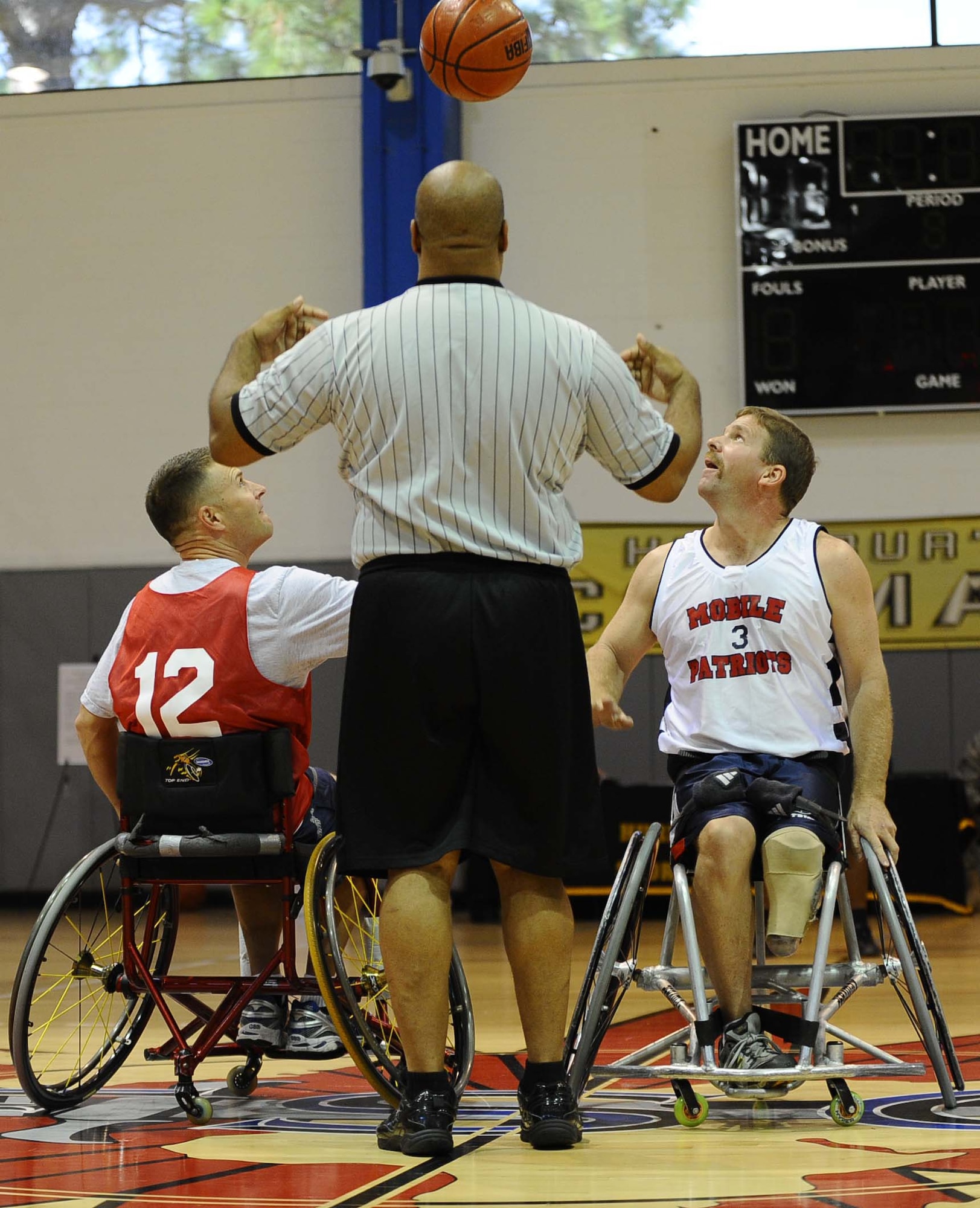 Col. Greg Lengyel, 1st Special Operations Wing commander, prepares to get the ball during the opening tip against a member of the Mobile Patriots, a National Wheelchair Basketball Association team, at the fourth annual Wheelchair Basketball Exhibition Game at the Aderholt Fitness Center at Hurlburt Field Oct. 1.  (U.S. Air Force photo by Senior Airman Julianne Showalter)