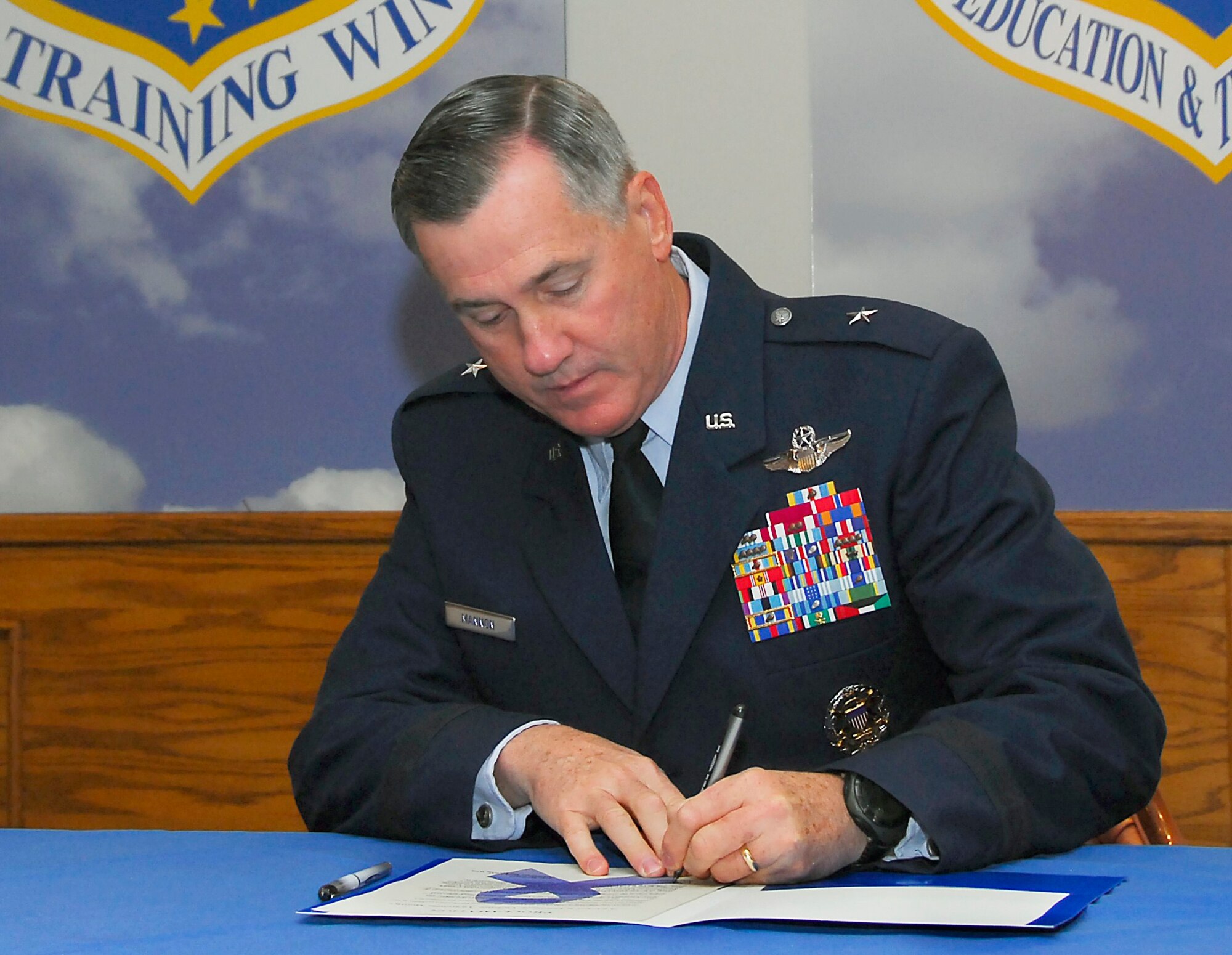 Brig. Gen. O.G. Mannon, 82nd Training Wing commander, signs a proclamation Oct. 2 to declare that Sheppard “will support October 2009 as Domestic Violence Awareness Month… to display our commitment to the health, wellness and safety of our community and our families.” During Domestic Violence Awareness month Sheppard wants to make sure everyone contributes to taking abuse out of the community. (U.S. Air Force photo/Harry Tonemah)