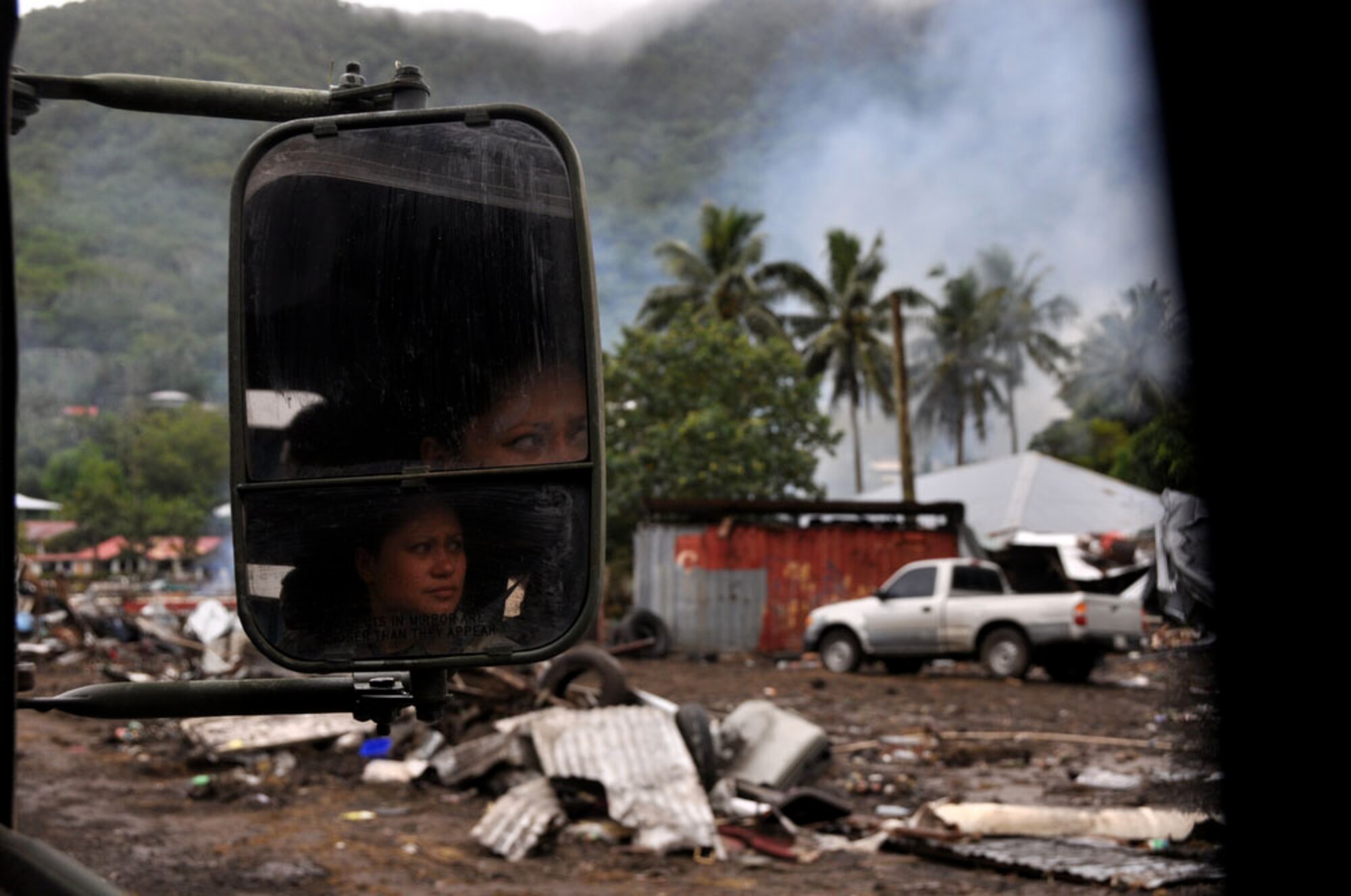 PAGO PAGO - 154th Medical Group/Chemical, Biological, Radiological/Nuclear and Explosives (CBRNE) Enhanced Response Force Package (CERFP), U.S. Air National Guardsmen, Technical Sergeant Carissa Maxson watches the shorelines of Pago Pago, American Samoa in disbelief as she drives by them on Oct. 1, 2009. Tech Sgt. Maxson is conducting assessments of the area after a tsunami caused a great amount of structural damage to the island and it's villages Sept. 29, 2009. (U.S.  Air Force photo/Tech Sgt. Cohen A. Young)