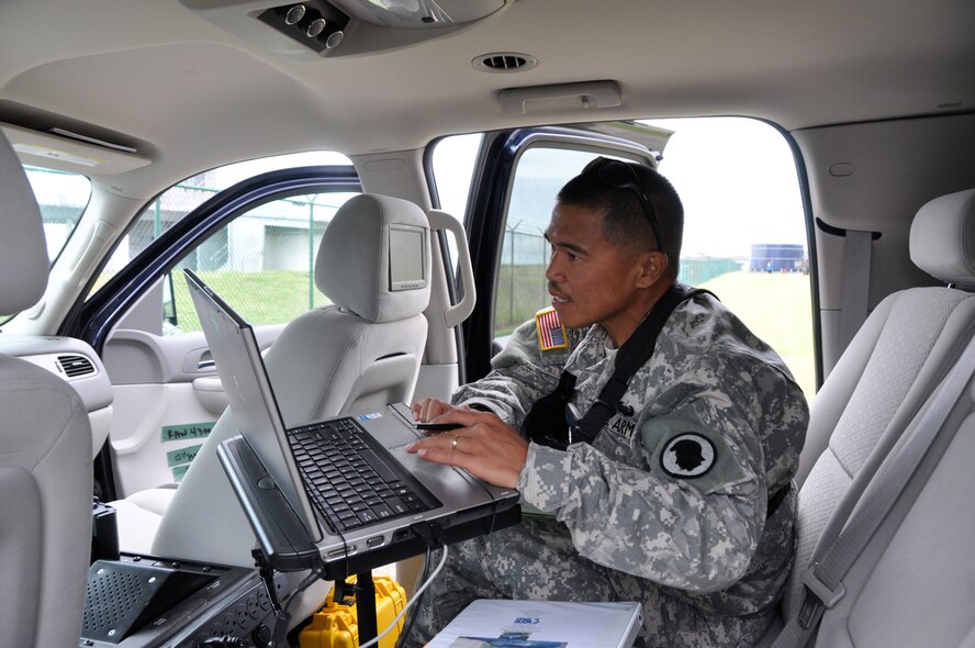 PAGO PAGO -  93rd Civil Support Team, U.S. Army National Guardsmen, Sergeant 1st Class Eli Pantil sets up mobile communication in his vehicle before his team departs the U.S. Army Reserve Center Pele Center for the village area of Pago Pago on Oct. 1, 2009 to assess damages caused by a tsunami that wiped out shorelines on Sept. 29, 2009. U.S. Army National Guardsmen Hawaii, 93rd Civil Support Team and U.S. Air National Guardsmen Hawaii arrived at the Pago Pago Airport on Sept. 29, 2009 to help relief efforts on the island. (U.S.  Air Force photo/Tech Sgt. Cohen A. Young)