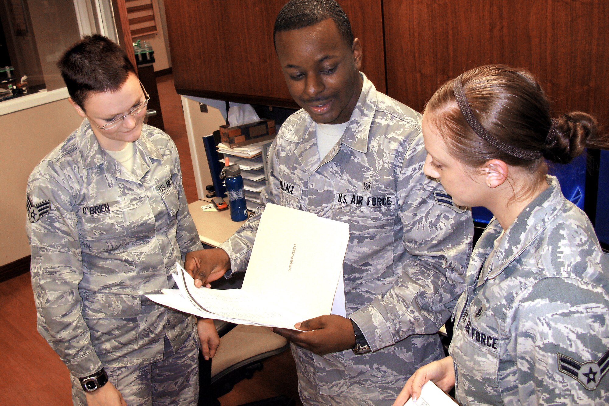 Senior Airman Hannah O'Brien, Airman 1st Class Brandon Wallace and Airman 1st Class Chelsey Morgan prepare for a flight arriving with patients being medically evacuated to the United States through the 779th Aeromedical Staging Facility at Andrews Air Force Base, Md. (Department of Defense photo/Donna Miles)