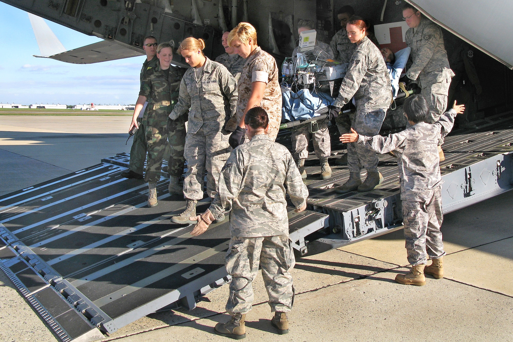 Airmen and Marines from the 779th Aeromedical Staging Facility at Andrews Air Force Base, Md., transports a severely wounded Soldier being medically evacuated from Iraq for advanced treatment care at Walter Reed Army Medical Center in Washington. (Department of Defense photo/Donna Miles)