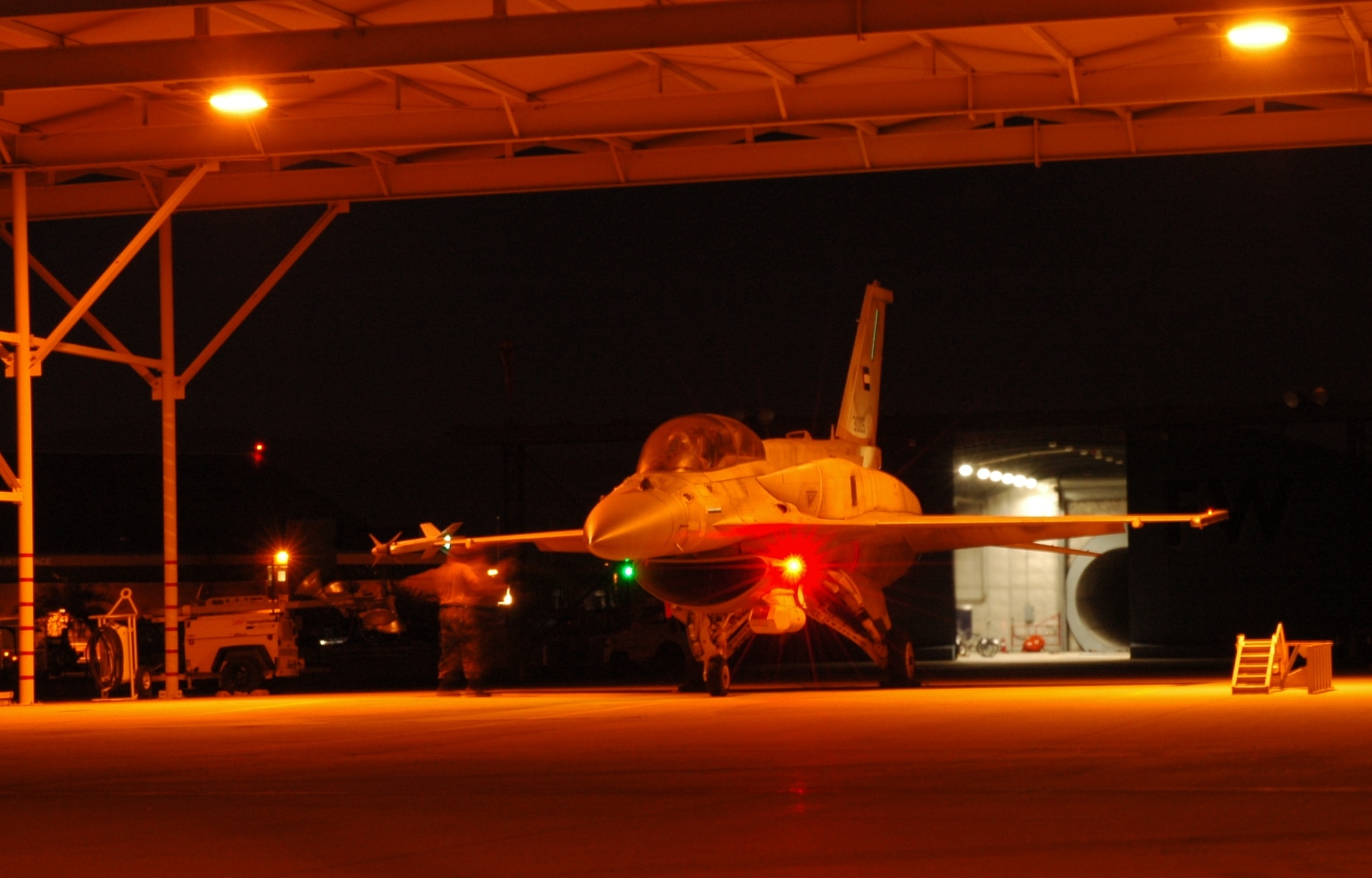 A crew chief from the 162nd Maintenance Group prepares to launch his F-16F Desert Falcon during a hot summer night. (Air National Guard photo by Maj. Gabe Johnson)