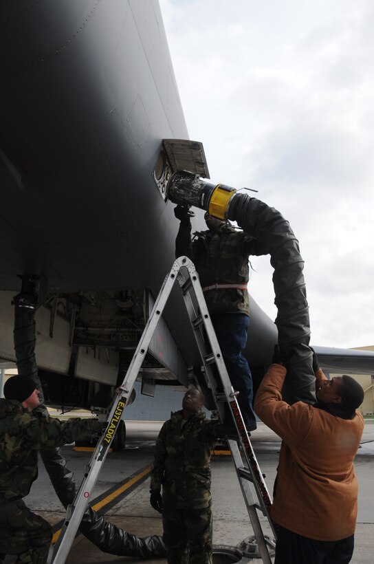 Crew chiefs from the 28th Aircraft Maintenance Squadron attach a Consolidated Aircraft Support System that externally bleeds air from a B-1B Lancer here, October 1.  The crew chiefs maintain and refuel B-1s, the backbone of America's long-range bomber force. (U.S. Air Force photo/Airman 1st Class Anthony Sanchelli)
