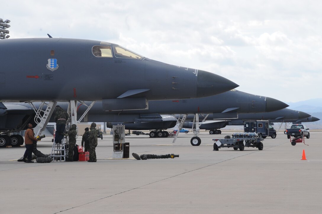 Crew chiefs from the 28th Aircraft Maintenance Squadron attach fuel lines to a B-1B Lancer here, October 1.  The crew chiefs maintain and refuel B-1s, the backbone of America's long-range bomber force. (U.S. Air Force photo/Airman 1st Class Anthony Sanchelli)