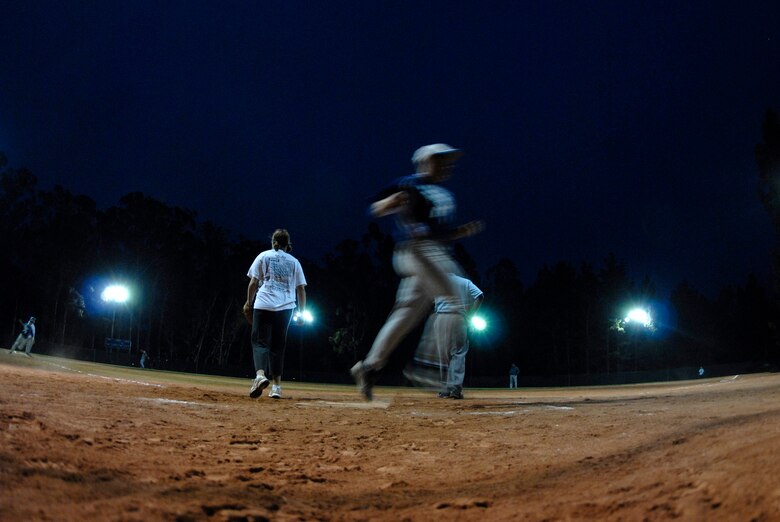 VANDENBERG AIR FORCE BASE, Calif. -- Airmen playing with the 532nd Training Squadron intramural softball team, score during a double play during their game between the 392nd Training Squadron here Sep. 28.  The 532nd TRS finished the game ahead 12-10. (U.S. Air Force photo/Senior Airman Andrew Satran)