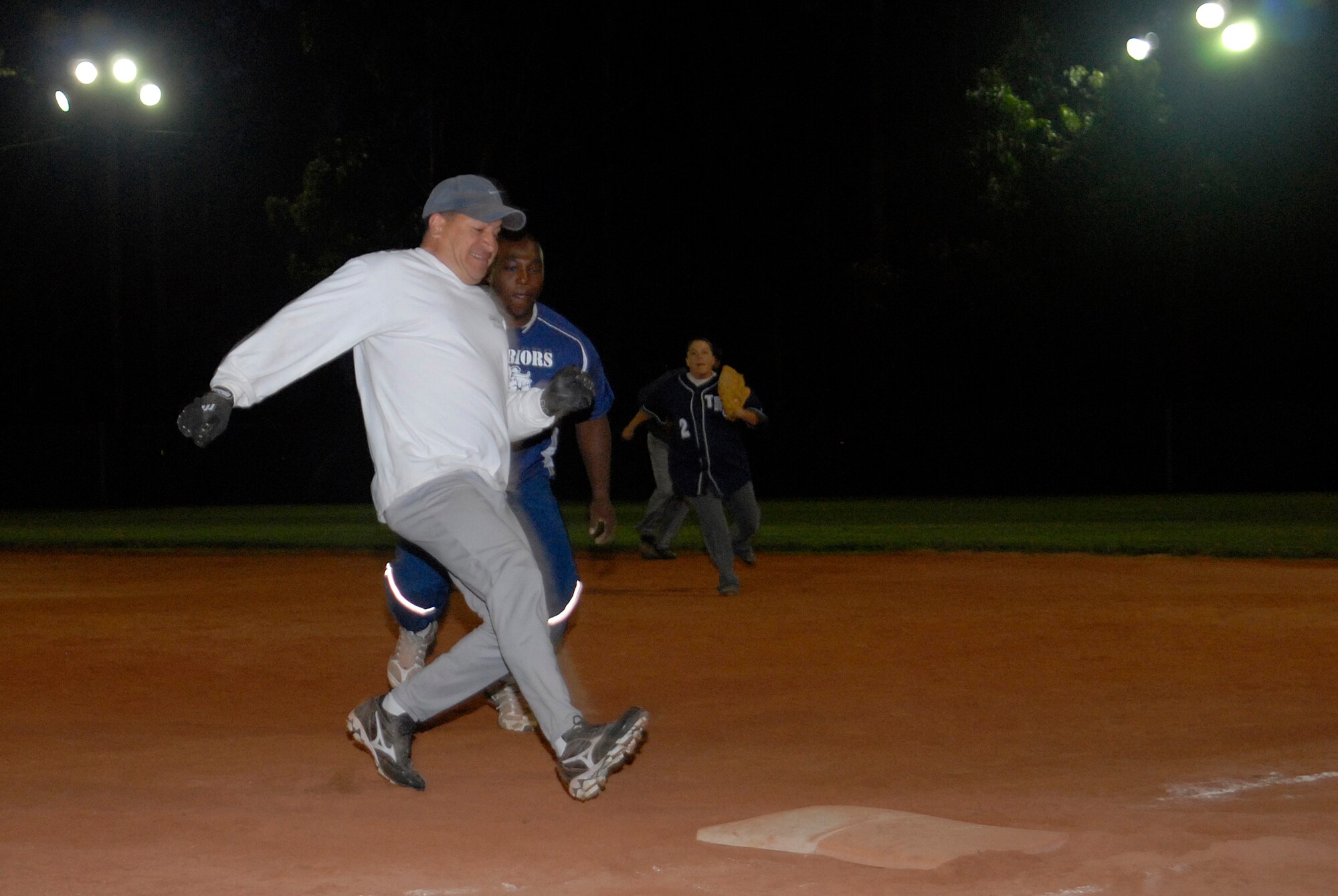 VANDENBERG AIR FORCE BASE, Calif. -- Ed Palacios, playing for the 392nd Training Squadron’s intramural softball team, runs to first base to avoid being tagged by first baseman, Roger Brooks, from the 532nd Training Squadron’s team, here Sep. 28.  The 532nd won the game 12-10.  (U.S. Air Force photo/Senior Airman Andrew Satran)