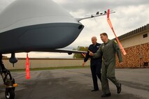 Lt. Gen. Harry M. Wyatt III, Director of the Air National Guard is given a tour of the MQ-9 Reaper on Hancock Field Air National Guard Base on 2 October by Lt. Col. Michael R. Smith, 138th Fighter Squadron Commander. The tour preceded the official ribbon cutting ceremony for the only MQ-9 Reaper Maintenance Field Training Detachment in the U.S. Air Force. (USAF Photo By: SSgt. James N. Faso II/RELEASED)