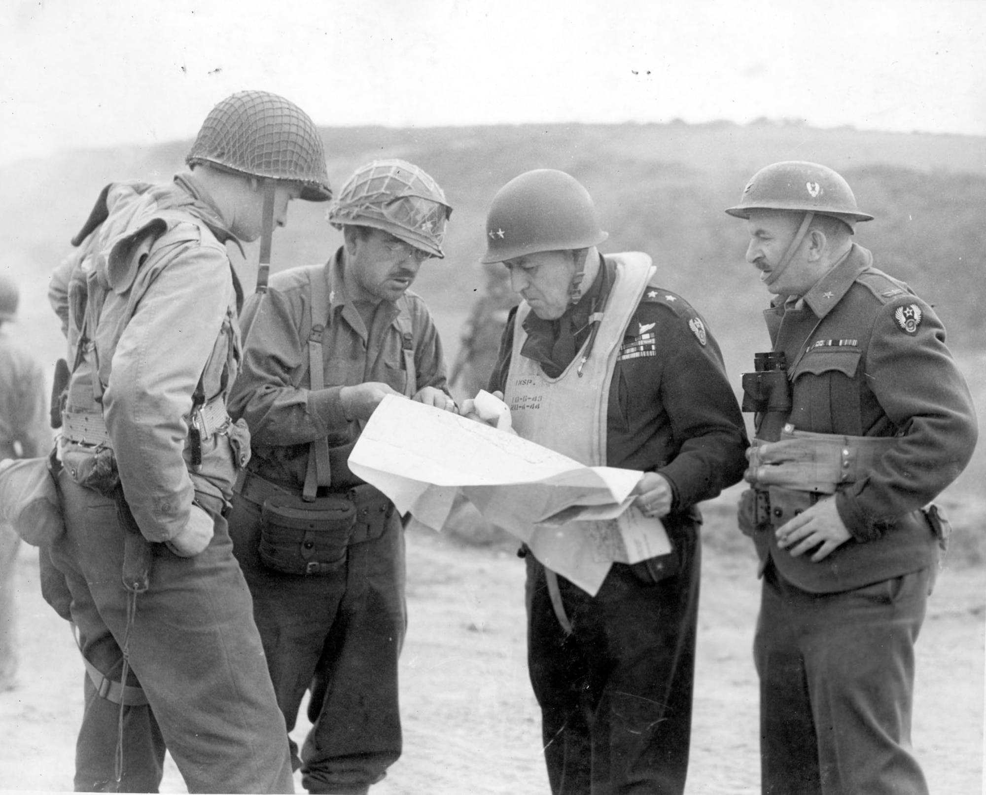 Maj. Gen. Ralph Royce (second from right), 9th Air Force deputy commander, with engineers on the Normandy beachhead one day after D-Day. (U.S. Air Force photo)