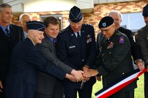 The assembled distinguished guests at the 174th Fighter Wing, Hancock Field Air National Guard Base, Syracuse, NY cut the ribbon and officially open the only MQ-9 Reaper Maintenance Field Training Detachment for the U.S. Air Force, Reserve and Air National Guard.
(From L to R) Maj. Gen. (Ret.) Robert A. Knauff, Maj. Gen. (Ret.) Paul Schemp, Brig. Gen. (Ret.) Curtis Irwin, Congressman Dan Maffei, Lt. Gen. Harry M. Wyatt III, MG Joseph Taluto, Maj. Gen. (Ret.) Thomas P. Maguire, Col. Anthony B. Basile. (USAF Photo By: SSgt. James N. Faso II/RELEASED)
