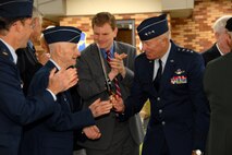 Lt. Gen. Harry M. Wyatt III, Director of the Air National Guard shakes hands with former 174th Fighter Wing Commander, Brig. Gen. (Ret.) Curtis Irwin as Congressman Dan Maffei claps immediately following the official ribbon cutting ceremony that officially opened the only MQ-9 Reaper Maintenance Field Training Detachment for the U.S. Air Force, Reserve and Air National Guard. (USAF Photo By: SSgt. James N. Faso II/RELEASED)