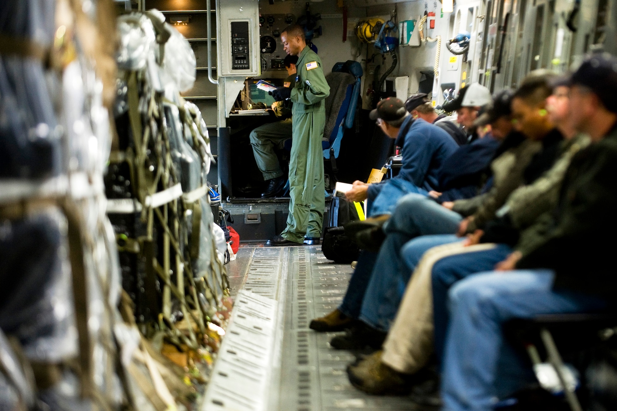 Tech. Sgt. Derrick Russell reviews a preflight checklist aboard a C-17 Globemaster III as Federal Emergency Management Agency representitives wait for takeoff Oct 1, 2009, at McChord Air Force Base, Wash. In the wake of a 7.6 magnitude undersea earthquake that caused a devastating tsunami to strike American Samoa, McChord AFB Airmen deployed a U.S.-based FEMA team to the region. Sergeant Russell is a 7th Airlift Squadron loadmaster. (U.S. Air Force photo/Abner Guzman) 