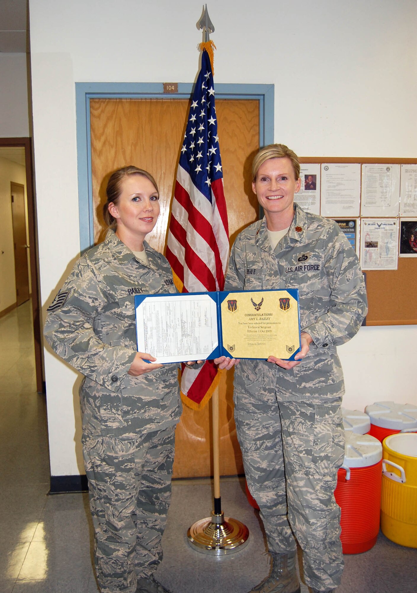 Tech. Sgt. Amy Bailey, 926th Mission Support Squadron (left), receives her promotion orders from Maj. Amy Boehle, 926th MSS commander, during her Promotion Enhancement Program ceremony here Sept. 30. Sergeant Bailey was the one applicant out of 11 nominated at 10th Air Force to be selected for the early promotion.