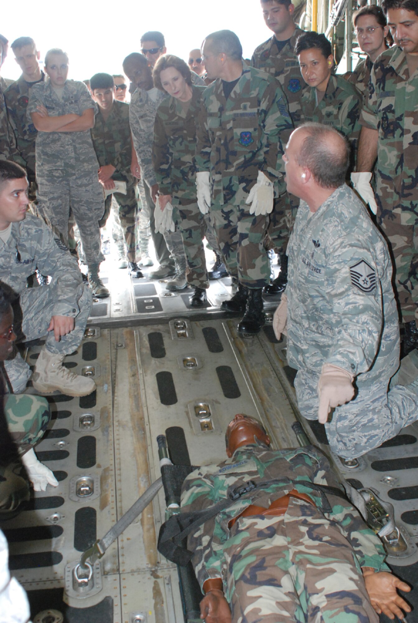 MSgt. Allan Folsom (foreground right), 301st Medical Squadron trainer, discusses how to properly secure a patient litter in a C-130 aircraft with Air Force and Navy Reservists during NAS JRB Ft Worth’s first-ever Air Force, Navy and Marine Reserve medical exercise. (U.S. Air Force photo/TSgt Stephen C. Bailey)