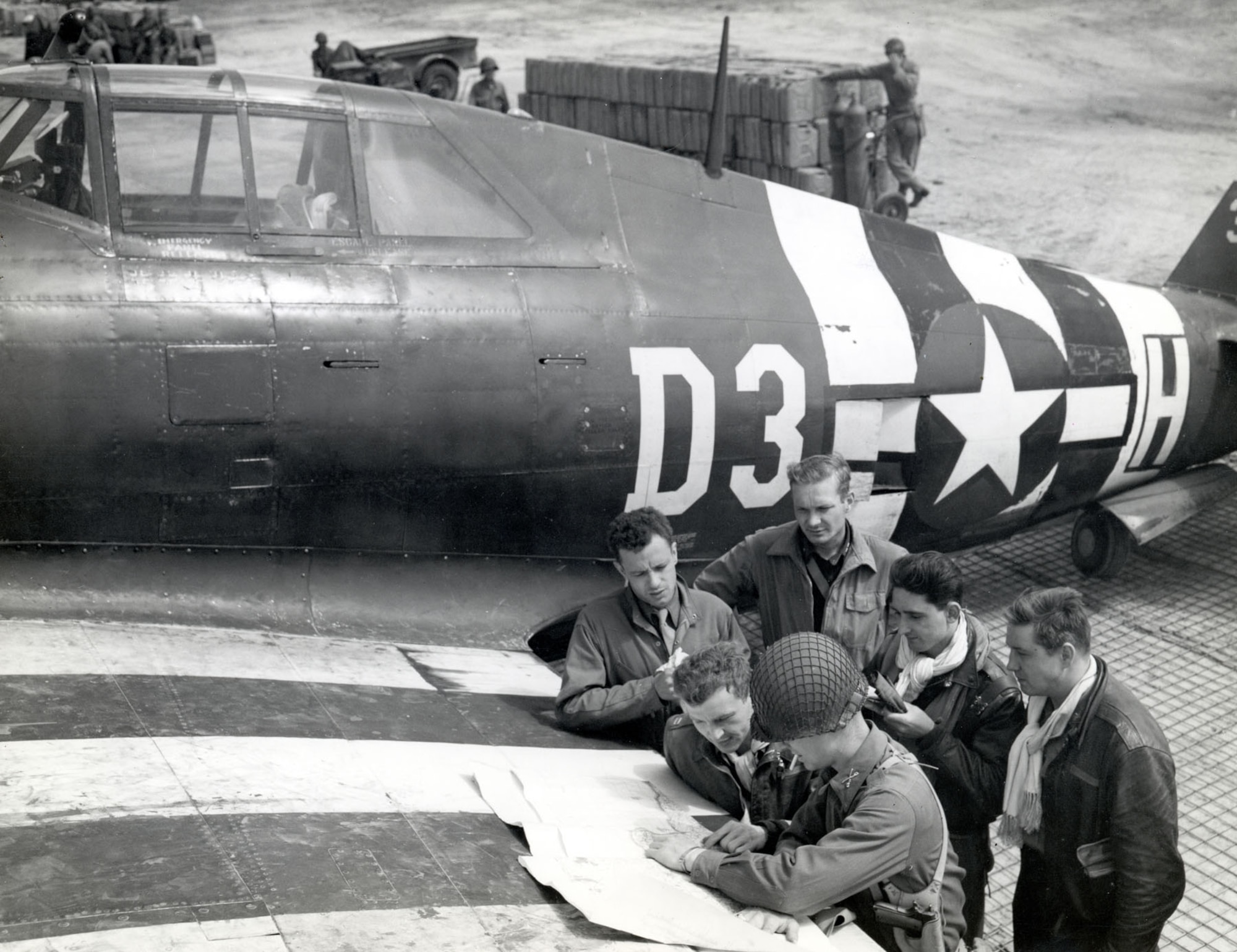 P-47 fighter-bomber pilots at a rough airstrip near St. Mere Eglise on June 15, 1944. By the end of August, all 18 of the 9th Air Force’s fighter-bomber and four of its medium bomber groups were based on the continent. (U.S. Air Force photo)