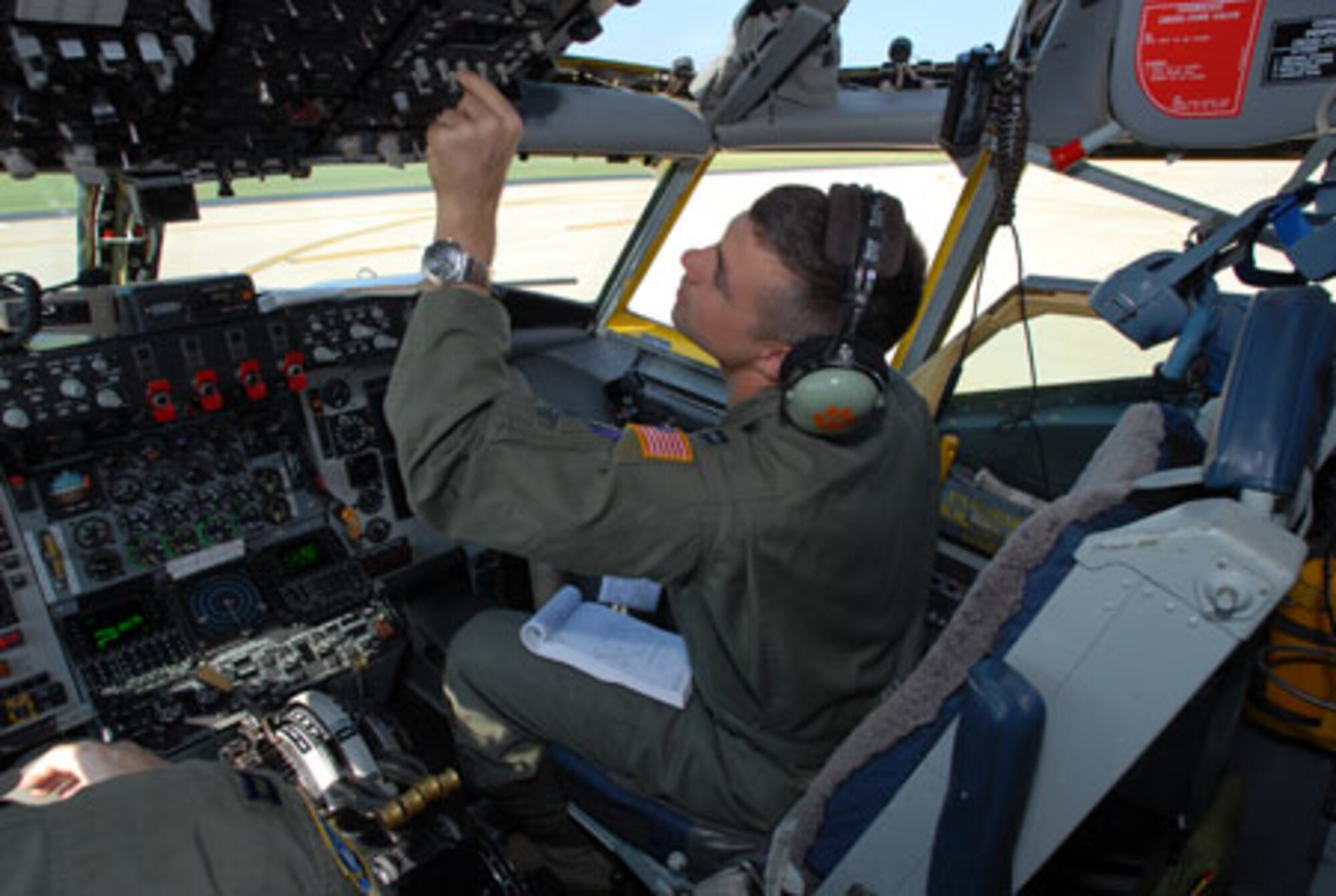SCOTT AIR FORCE BASE, Ill. -- Capt. Matt Mills, a KC-135(R) Stratotanker pilot with the 906th Air Refueling Squadron, reviews a pre-flight checklist prior to an aerial refueling mission. The flight on Sept 9 marked the first time that an all Active Duty crew flew planes owned and maintained by the 126th Air Refueling Wing, Illinois Air National Guard, Scott Air Force Base, Ill. (U.S. Air Force photo by Master Sgt. Ken Stephens)

