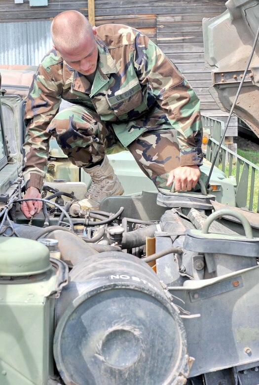SOTO CANO AIR BASE, Honduras — Seaman Christian Mewes, a medical element hospitalman (HN), performs some preventative maintenance checks on a humvee Sept. 25 at the MEDEL motorpool. HN Mewes won the Joint Task Force-Bravo Trooper of the Quarter Sept. 15, proving that in a joint environment excellence is recognized regardless of the branch of service. He is deployed from Yokosuka, Japan, and was the first Sailor in history to win Trooper of the Quarter for JTF-Bravo (U.S. Air Force photo/Master Sgt. Mike Tate).