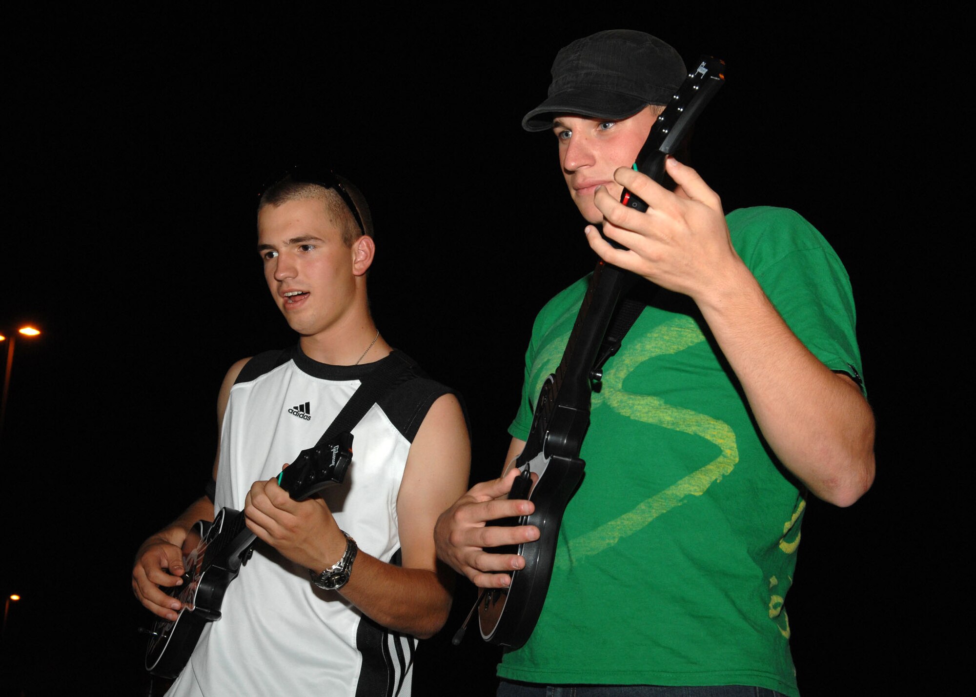 Airman 1st Class Ryan Heatley, 355th Equipment Maintenance Squadron, and Airman 1st Class Paul Baker, 612th Air Operations Center, play guitar hero Sept. 25 at the Summer Spash 2009 event at the base's outdoor pool. The event, which attracted more than 75 Airmen, was sponsored by the Culture of Responsible Choices, and marked the end of the summer season and the closing of the outdoor pool. CoRC is a program that emphasizes personal responsibility and accountability for decision-making and behavior on and off duty. (U.S. Air Force photo/Airman Jerilyn Quintanilla)